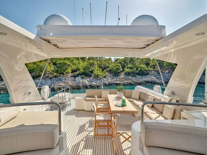a deck with a table and chairs aboard PAREAKKI Yacht for Sale
