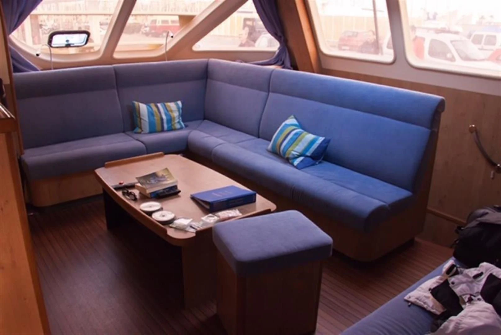 a couch with a coffee table aboard HELICAT RED Yacht for Sale