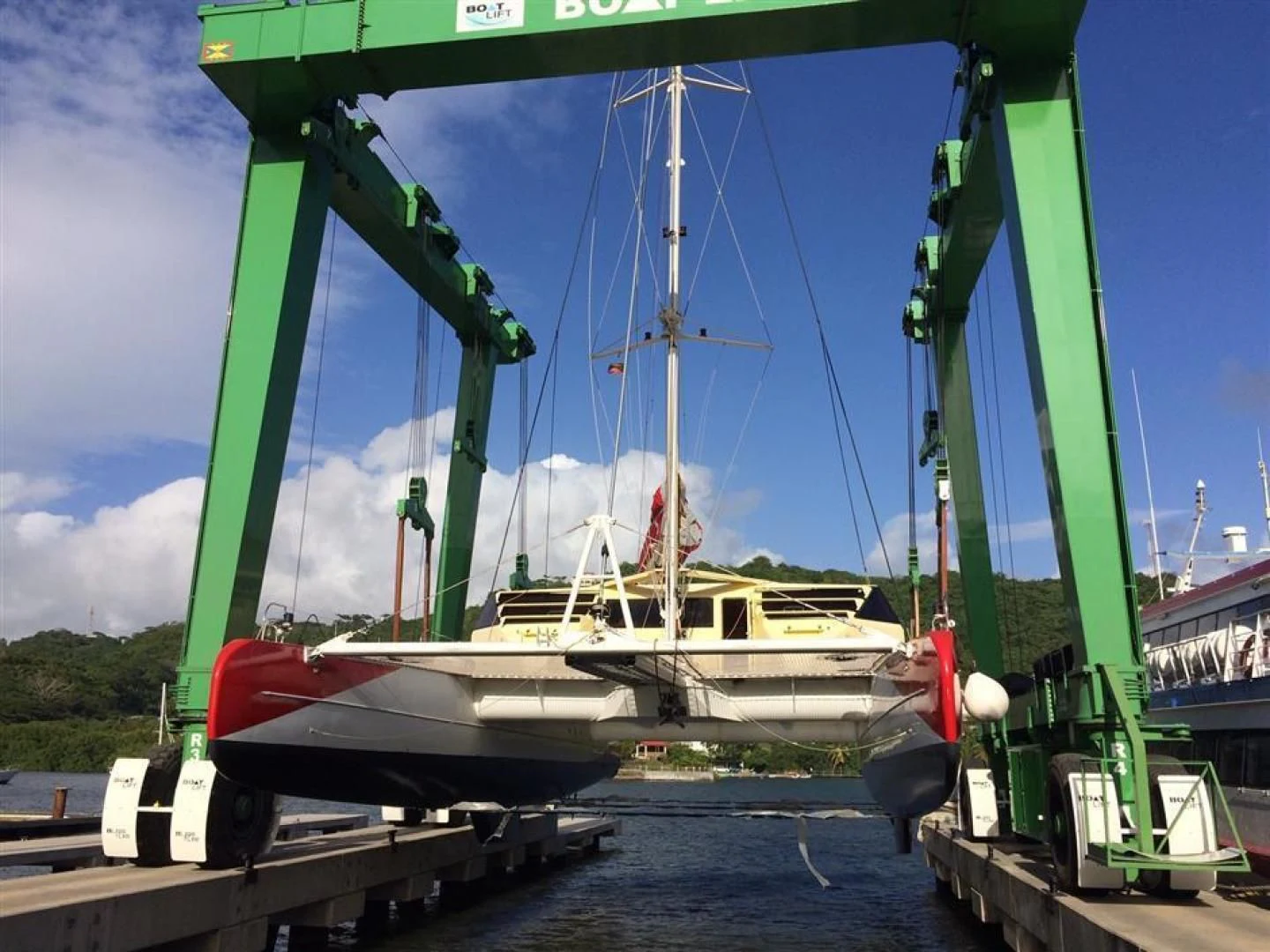 a boat docked at a pier aboard HELICAT RED Yacht for Sale