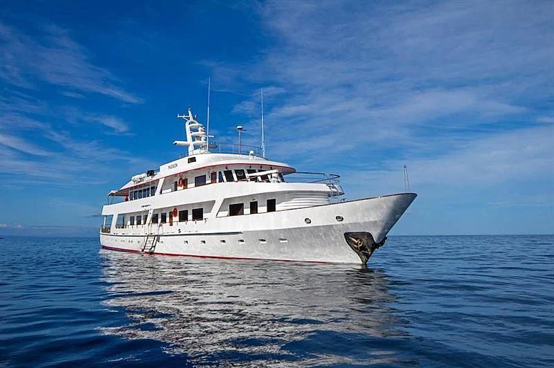 a large white boat in the water aboard PASSION Yacht for Sale