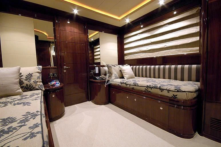 a bedroom with a bed and a wood door aboard TWO KAY Yacht for Sale