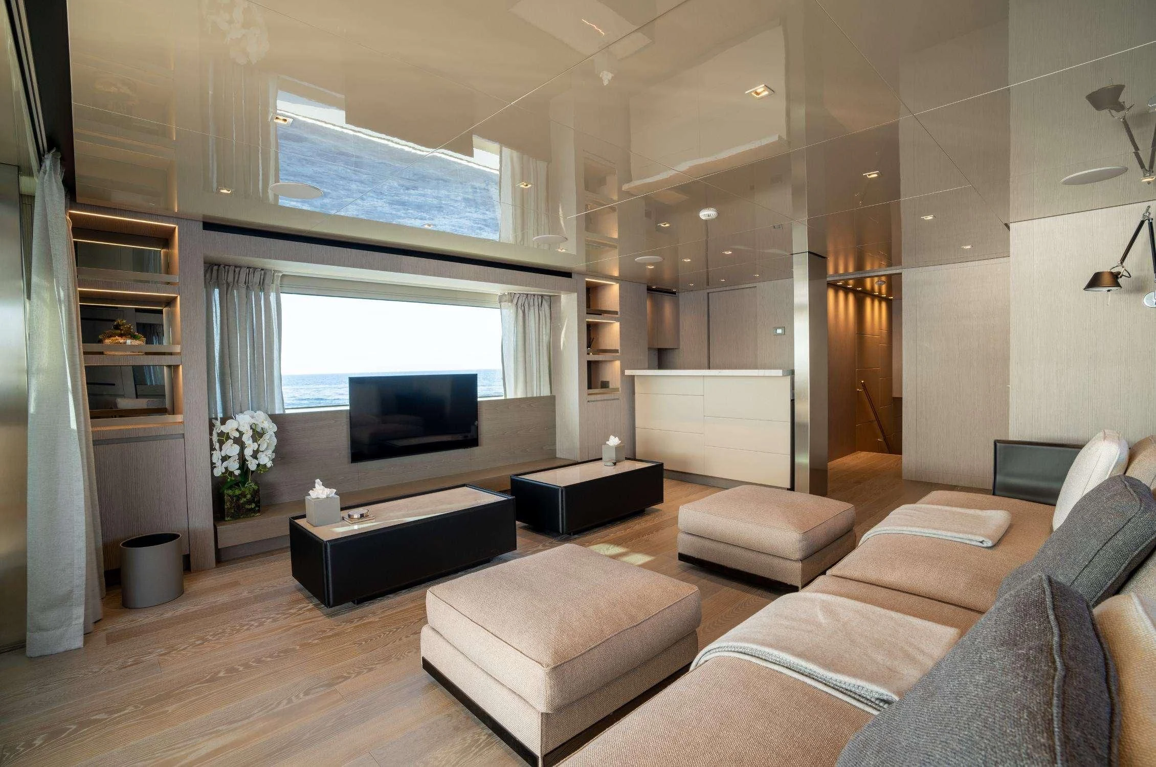 a living room with a large screen tv and a large window aboard LANCE Yacht for Sale