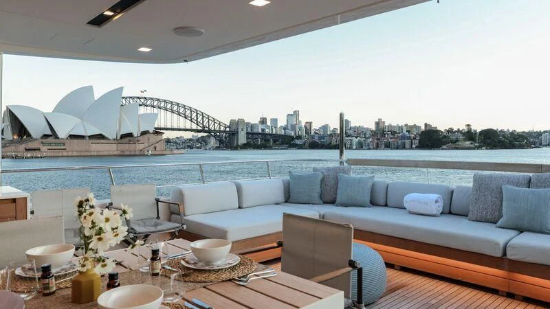 a large living room with a large body of water and a large city landscape aboard LANCE Yacht for Sale