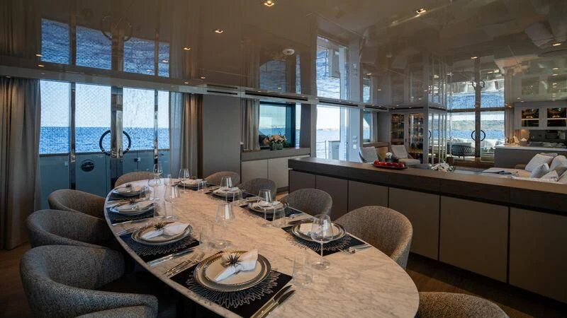 a large kitchen with a table set aboard LANCE Yacht for Sale
