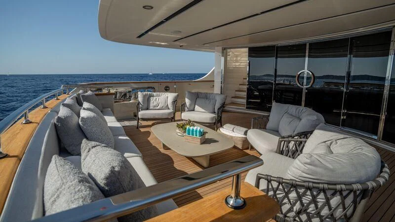 a living room with a large balcony aboard LANCE Yacht for Sale
