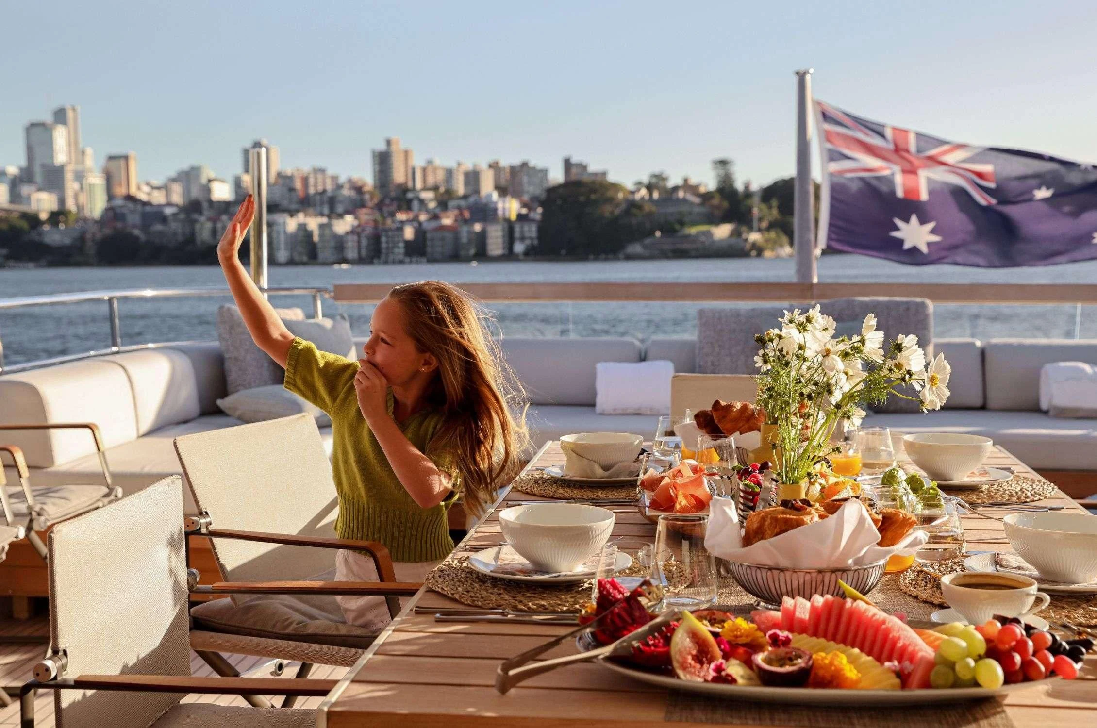 a woman sitting at a table with food on it aboard LANCE Yacht for Sale