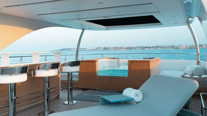 a room with a bed and chairs aboard LANCE Yacht for Sale