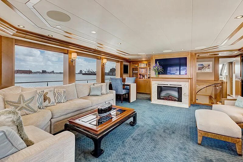 a living room with a fireplace aboard JESTSTREAM Yacht for Sale