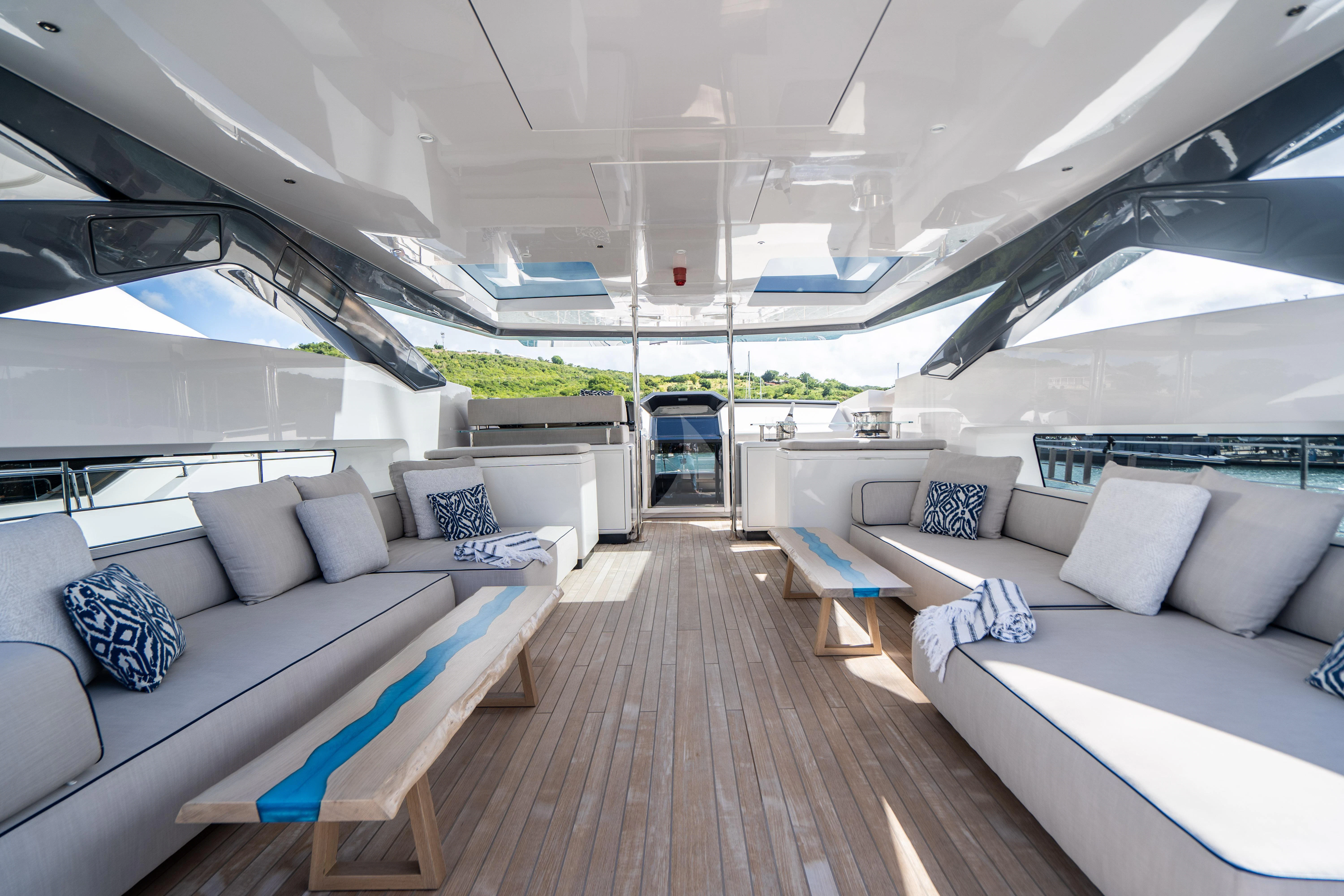a large living room with a wood floor and white couches aboard NEVER BLUE Yacht for Sale