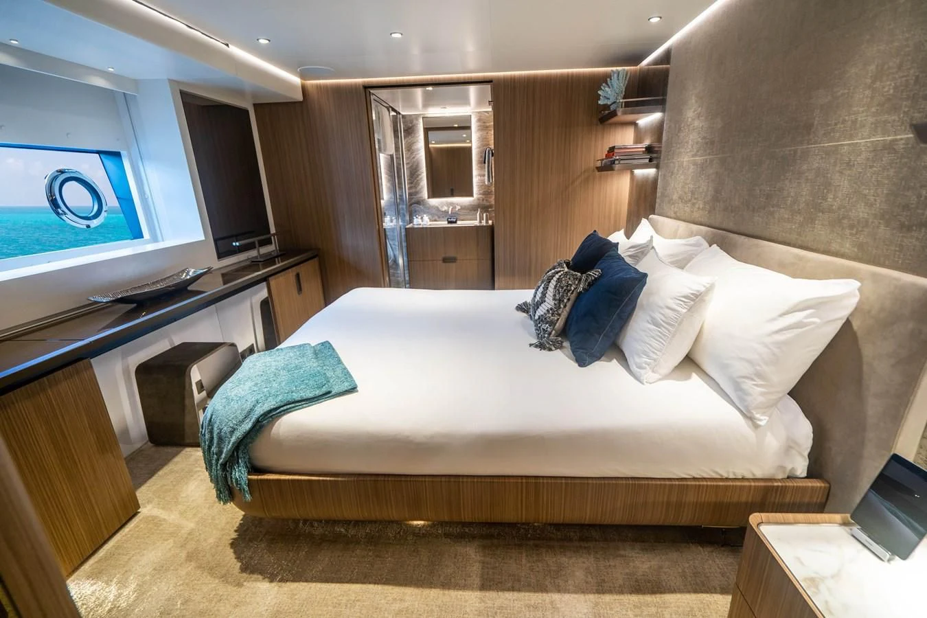 a bed with pillows and a television aboard NEVER BLUE Yacht for Sale