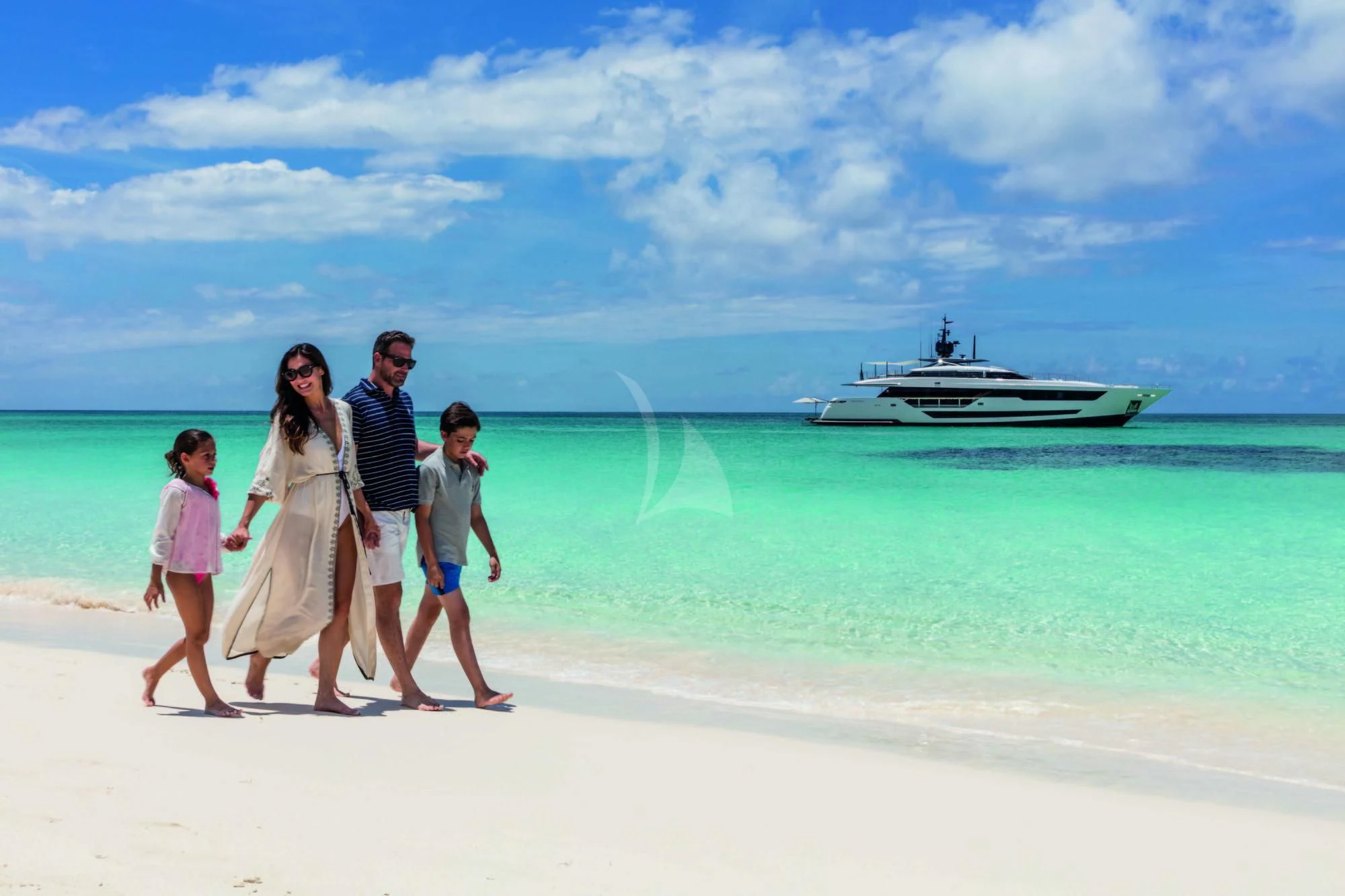 a family posing on a beach aboard NEVER BLUE Yacht for Sale