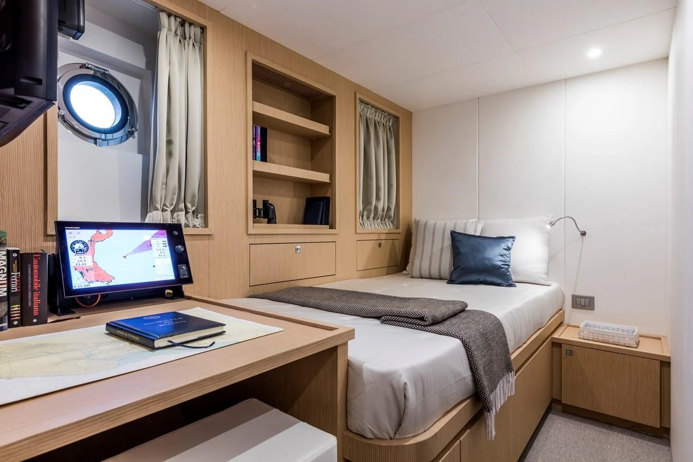 a bedroom with a bed desk and a computer aboard NEVER BLUE Yacht for Sale