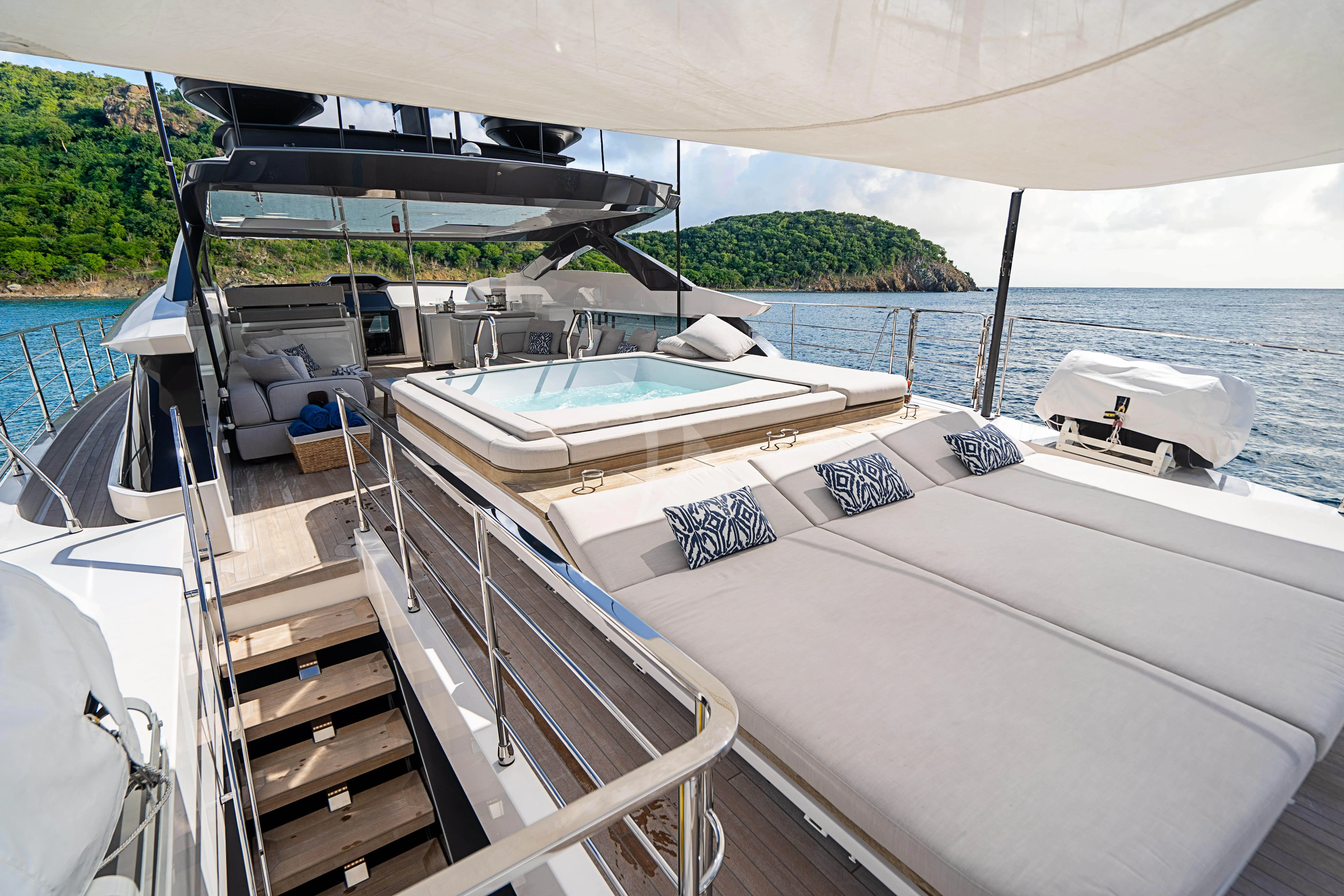 a boat with a deck and a dock with a railing and trees in the background aboard NEVER BLUE Yacht for Sale