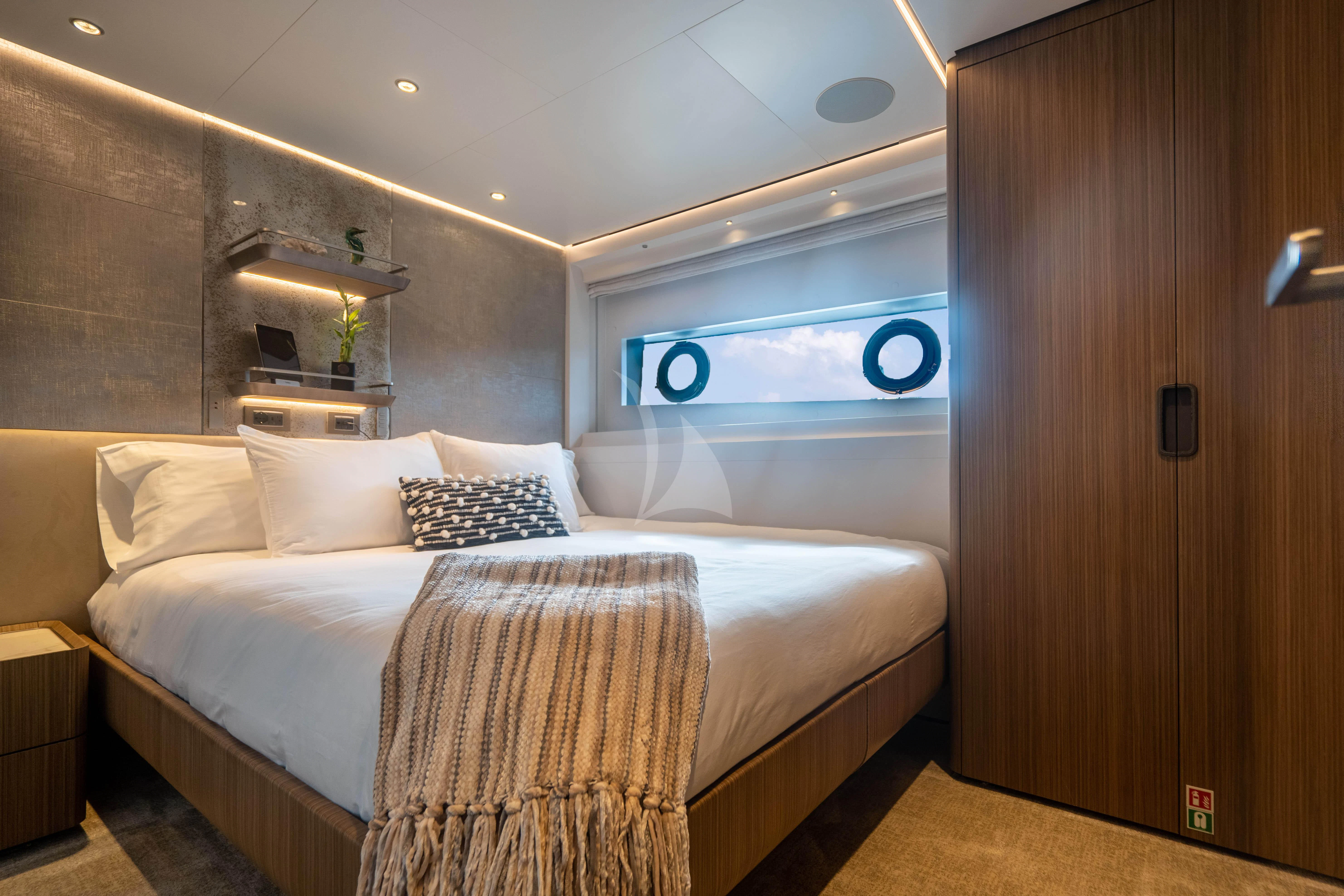 a bed with a white bed aboard NEVER BLUE Yacht for Sale