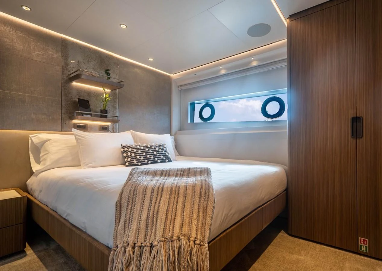 a bed with a white bed aboard NEVER BLUE Yacht for Sale