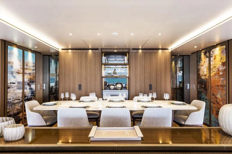 a large room with a table and chairs aboard NEVER BLUE Yacht for Sale