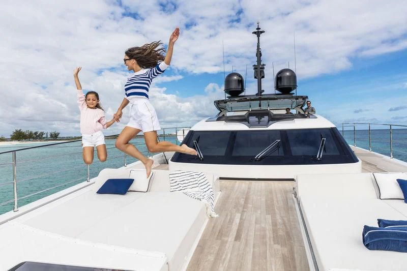 a person and a girl jumping on a boat aboard NEVER BLUE Yacht for Sale
