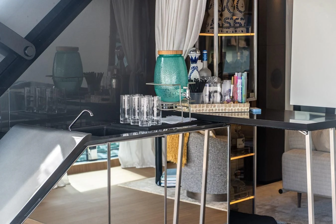 a table with a lamp and a piano in a room with a window aboard NEVER BLUE Yacht for Sale