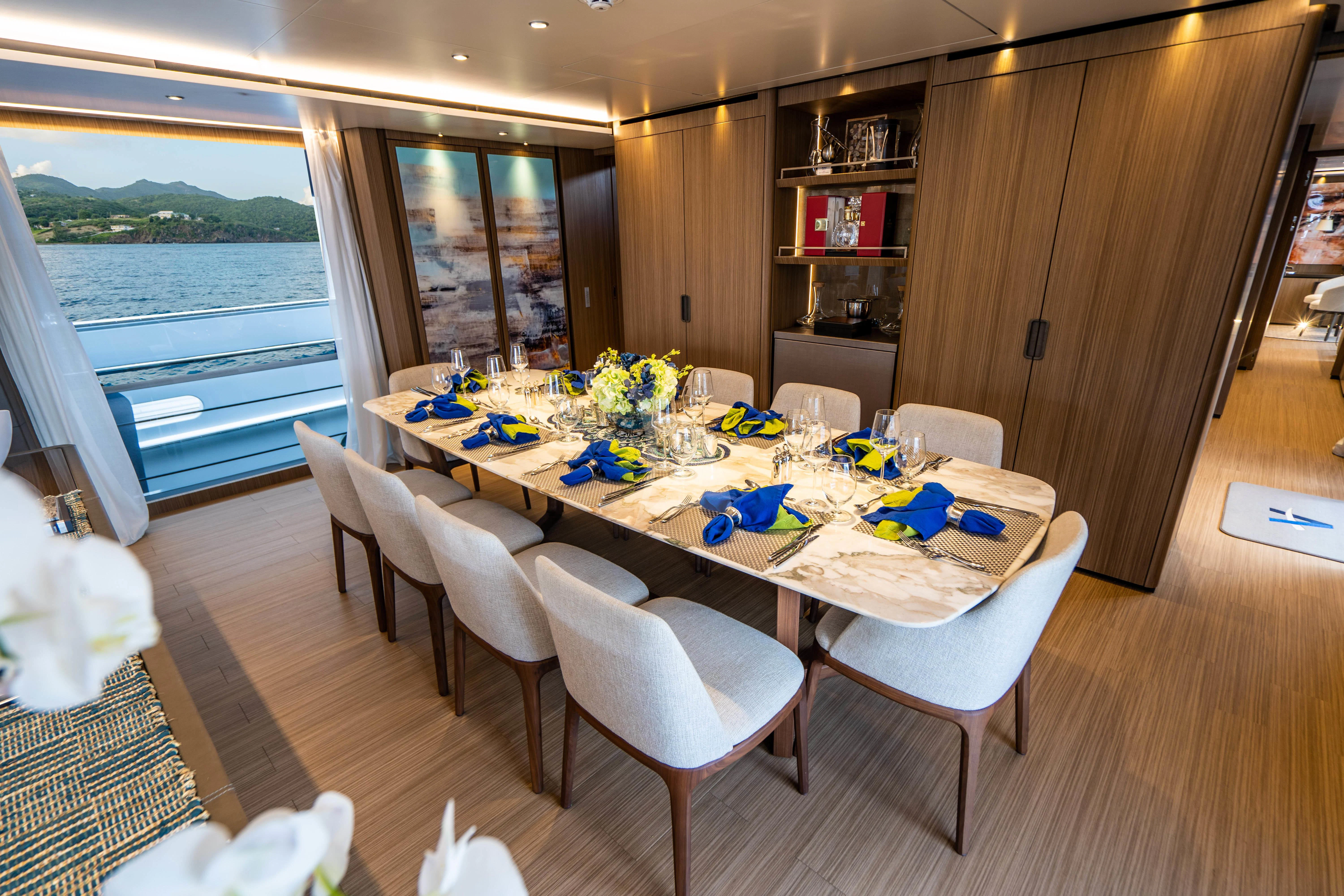 a dining room with a table and chairs aboard NEVER BLUE Yacht for Sale