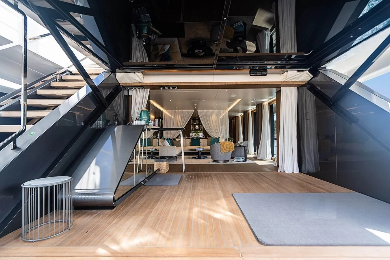 a room with a wood floor and a large metal staircase aboard NEVER BLUE Yacht for Sale