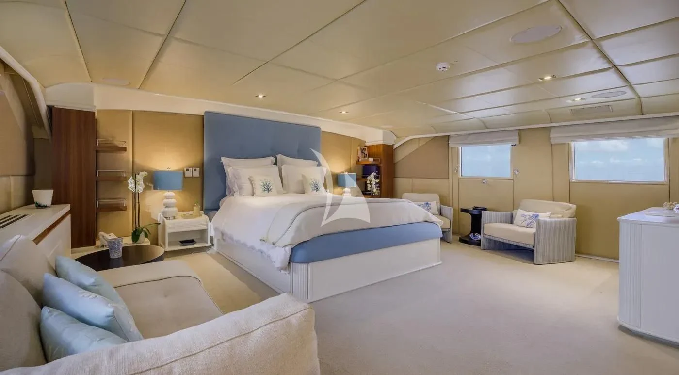 a room with a bed and a couch aboard ITOTO Yacht for Charter