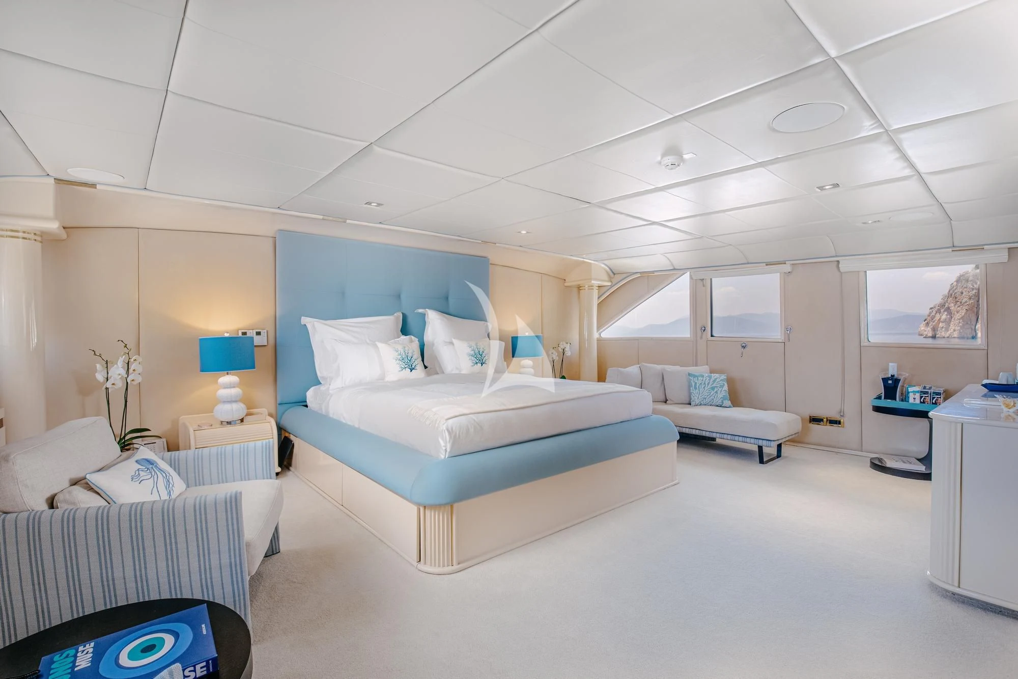 a room with a bed and a couch aboard ITOTO Yacht for Charter