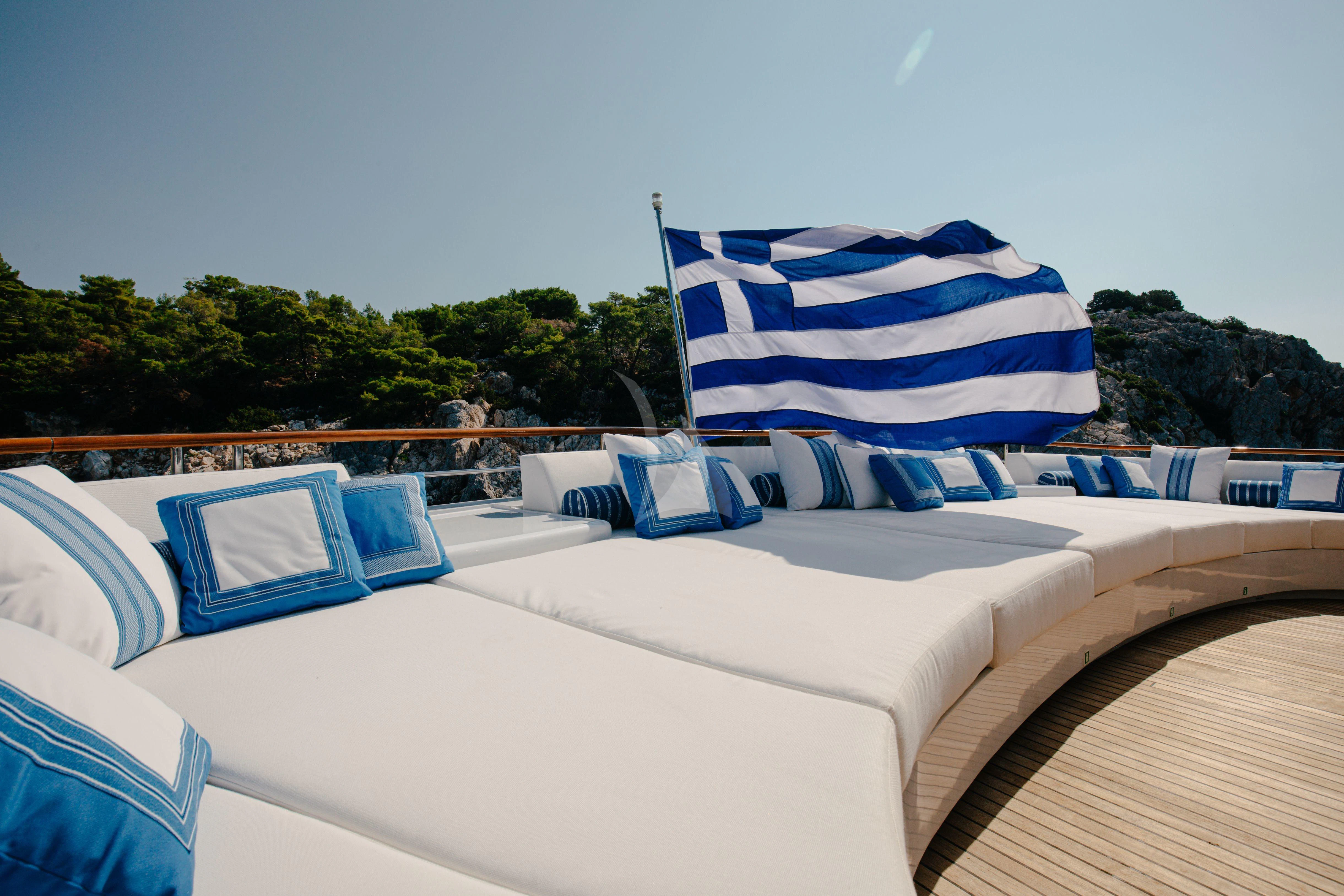 a bed with blue and white pillows aboard ITOTO Yacht for Charter