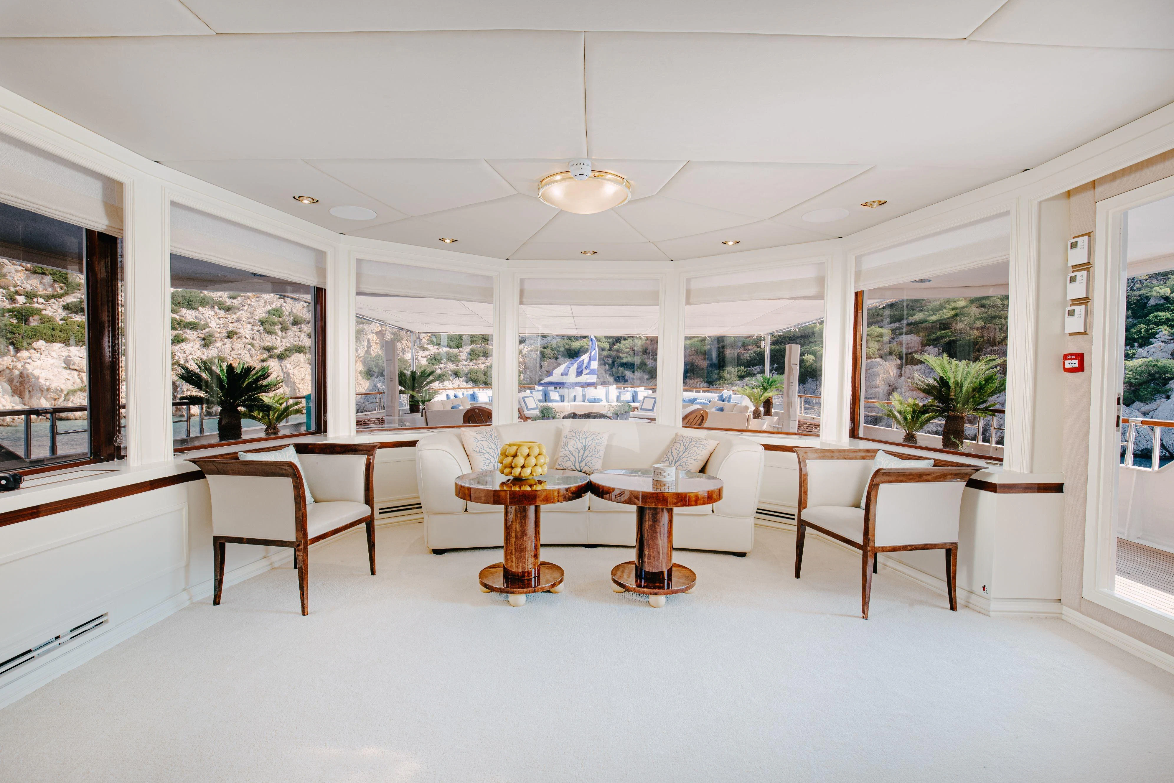 a room with tables and chairs aboard ITOTO Yacht for Charter