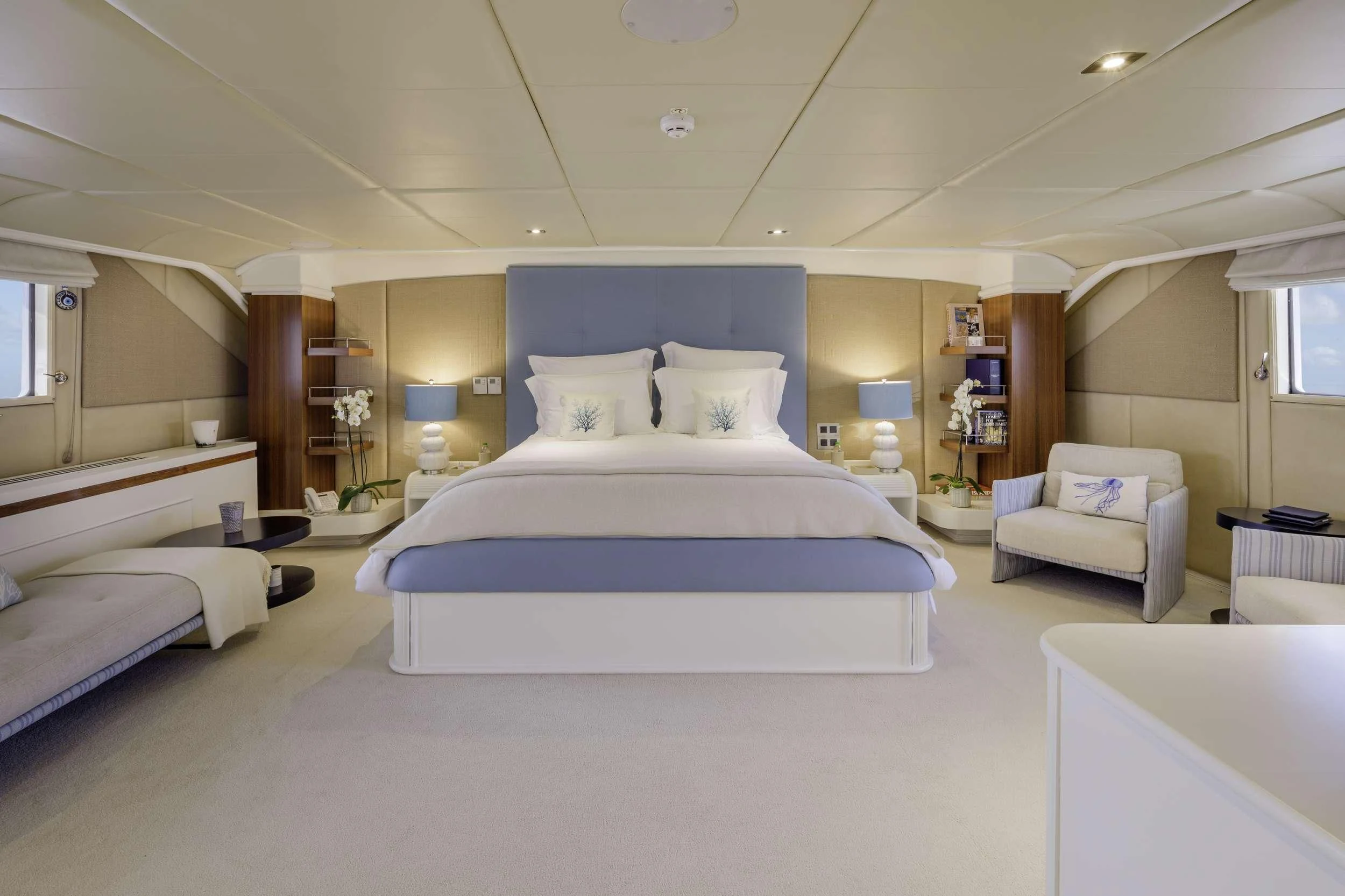 a room with a bed and a chair aboard ITOTO Yacht for Charter