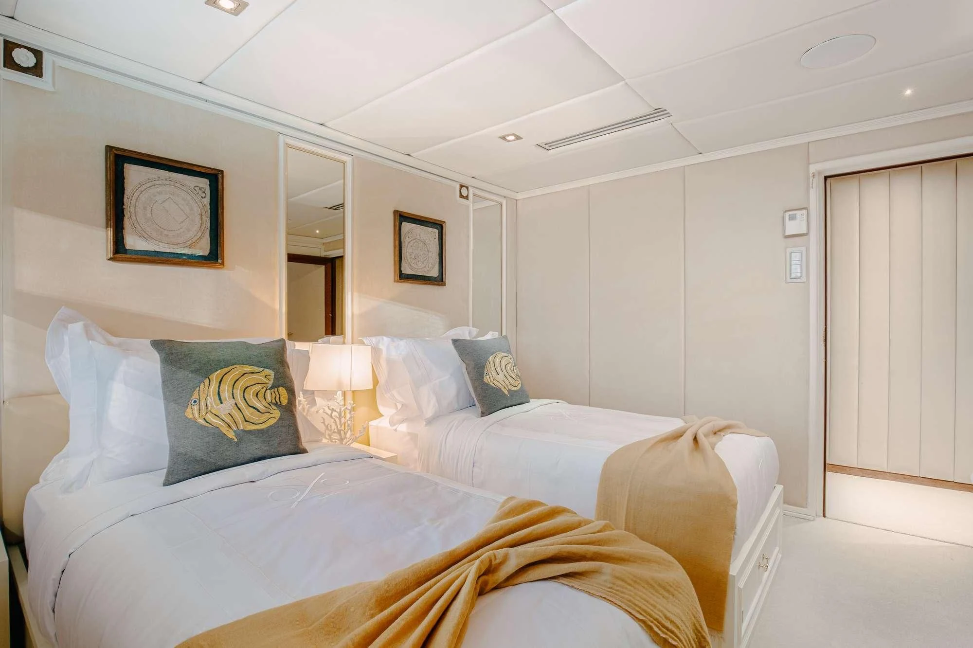a couple of beds in a hotel room aboard ITOTO Yacht for Charter