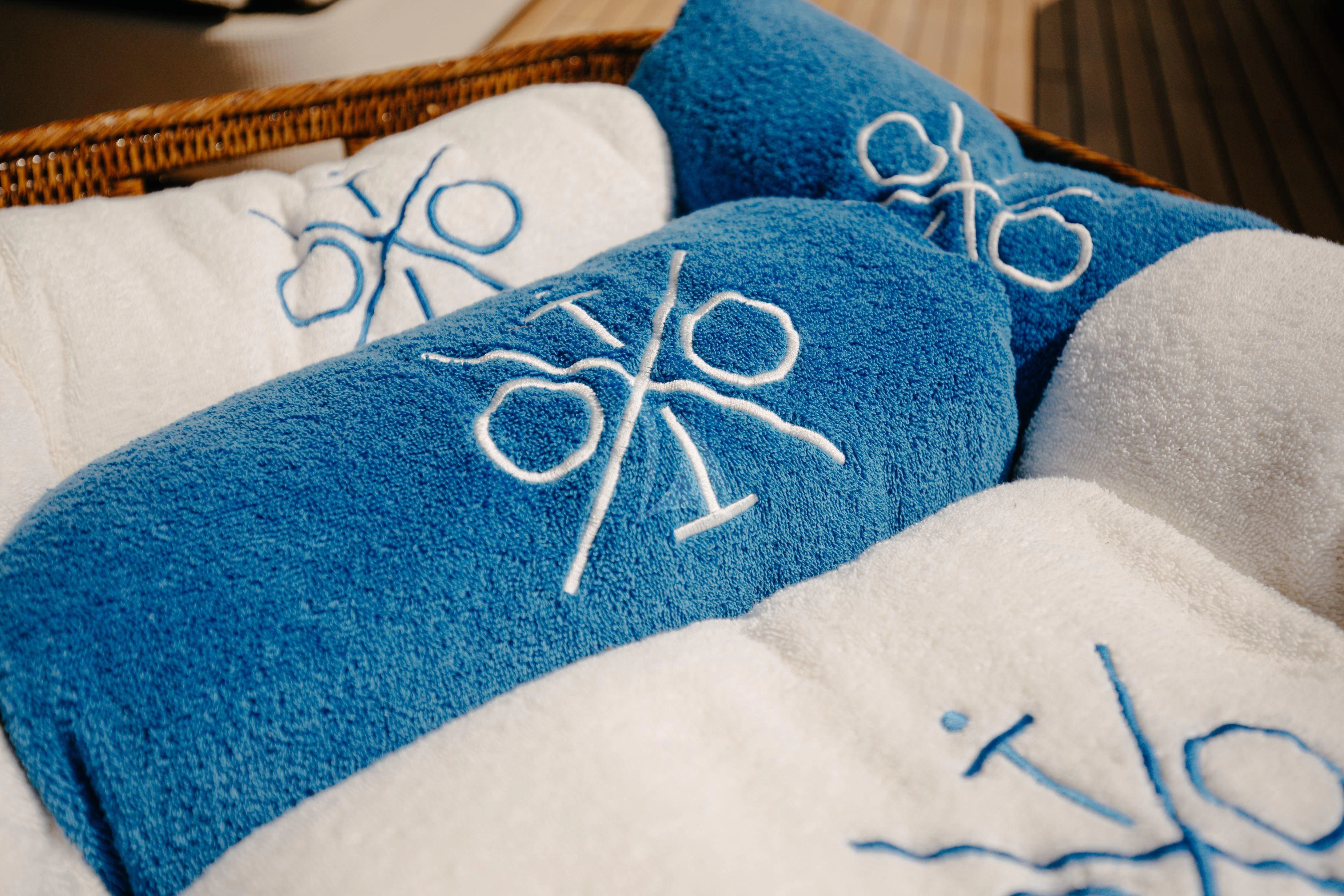 a blue pillow with a drawing on it aboard ITOTO Yacht for Charter