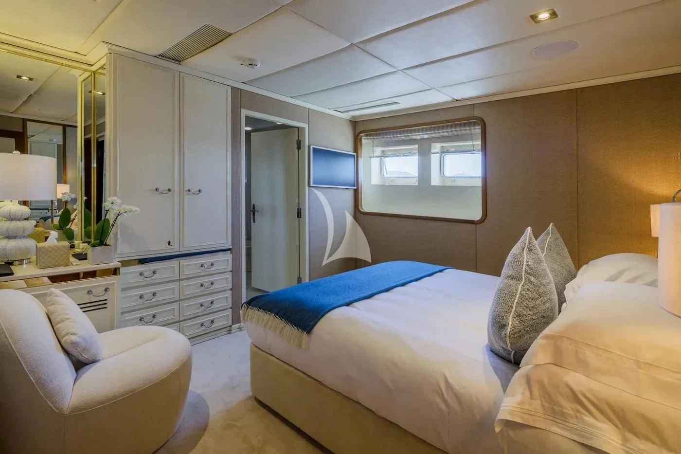 a bedroom with a bed and a chair aboard ITOTO Yacht for Charter