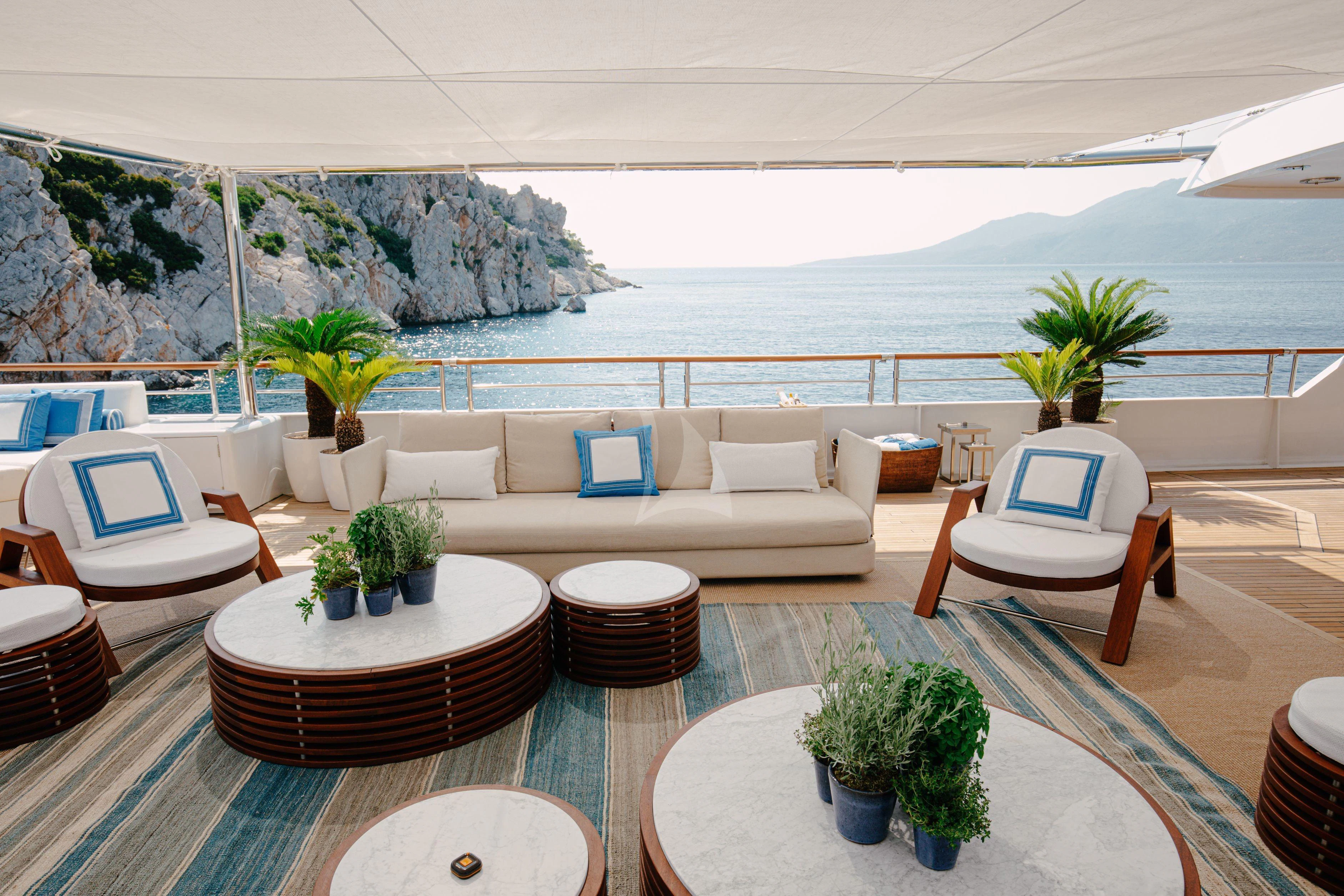 a living room with a large body of water and plants aboard ITOTO Yacht for Charter