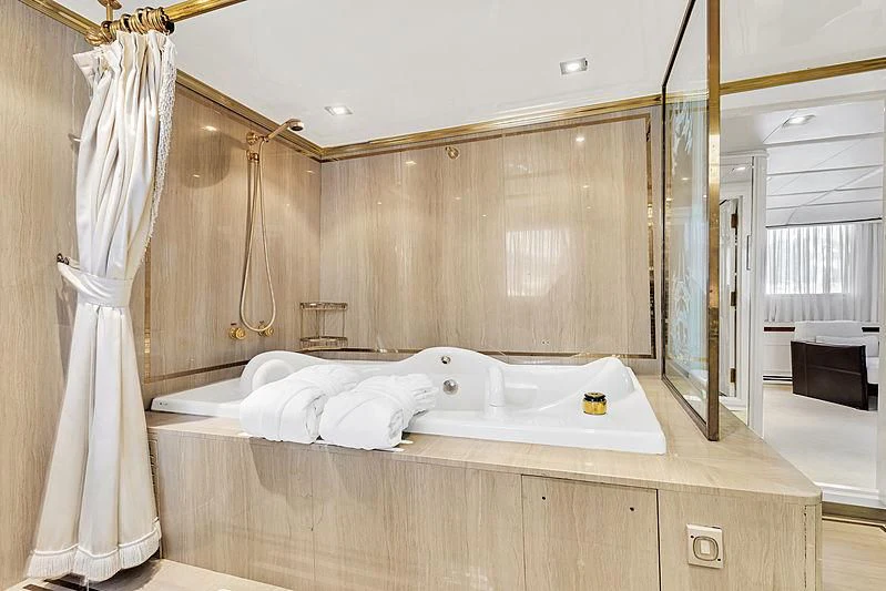 a bedroom with a bed and a mirror aboard ITOTO Yacht for Charter