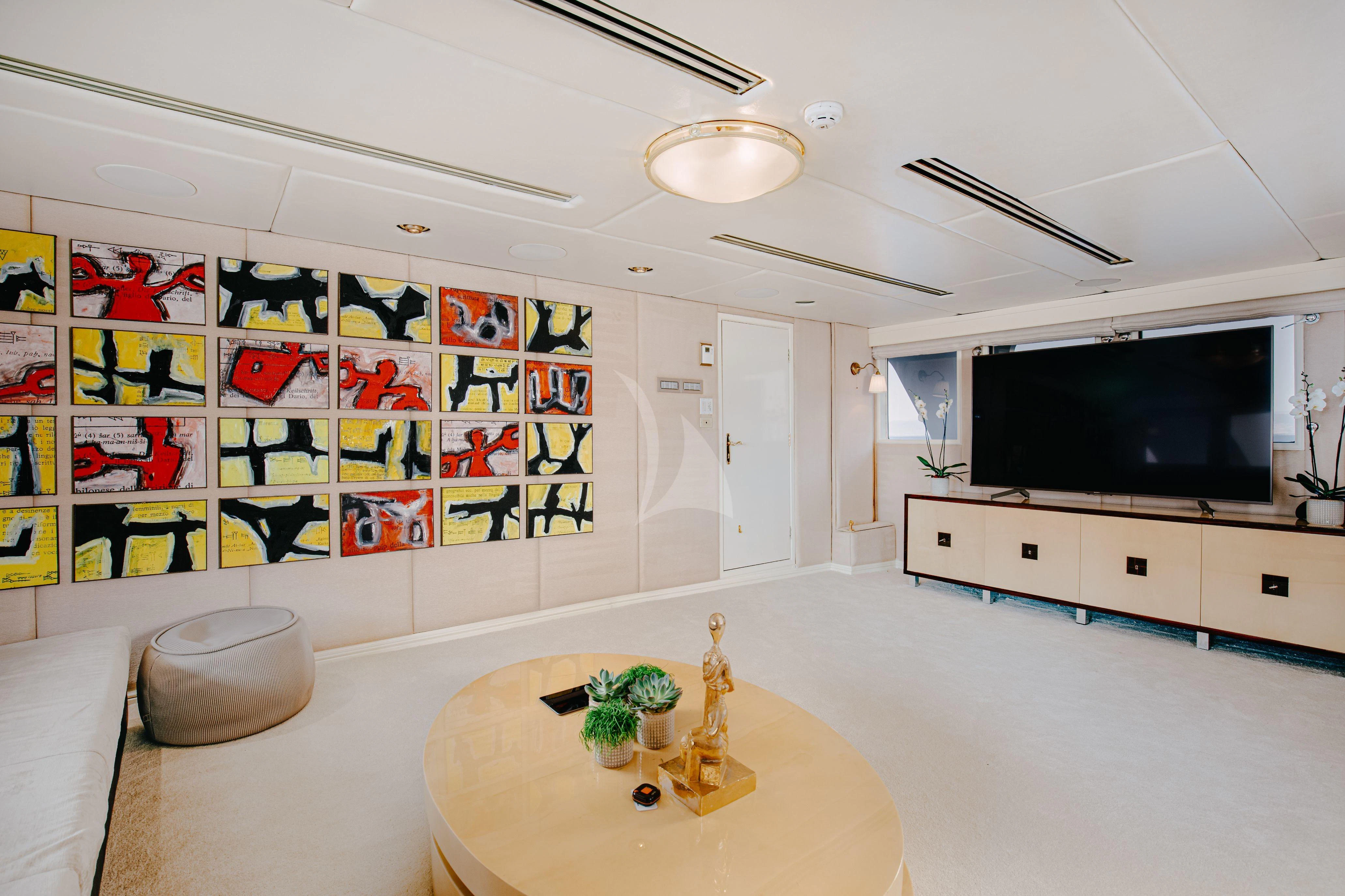 a room with a table and tv aboard ITOTO Yacht for Charter