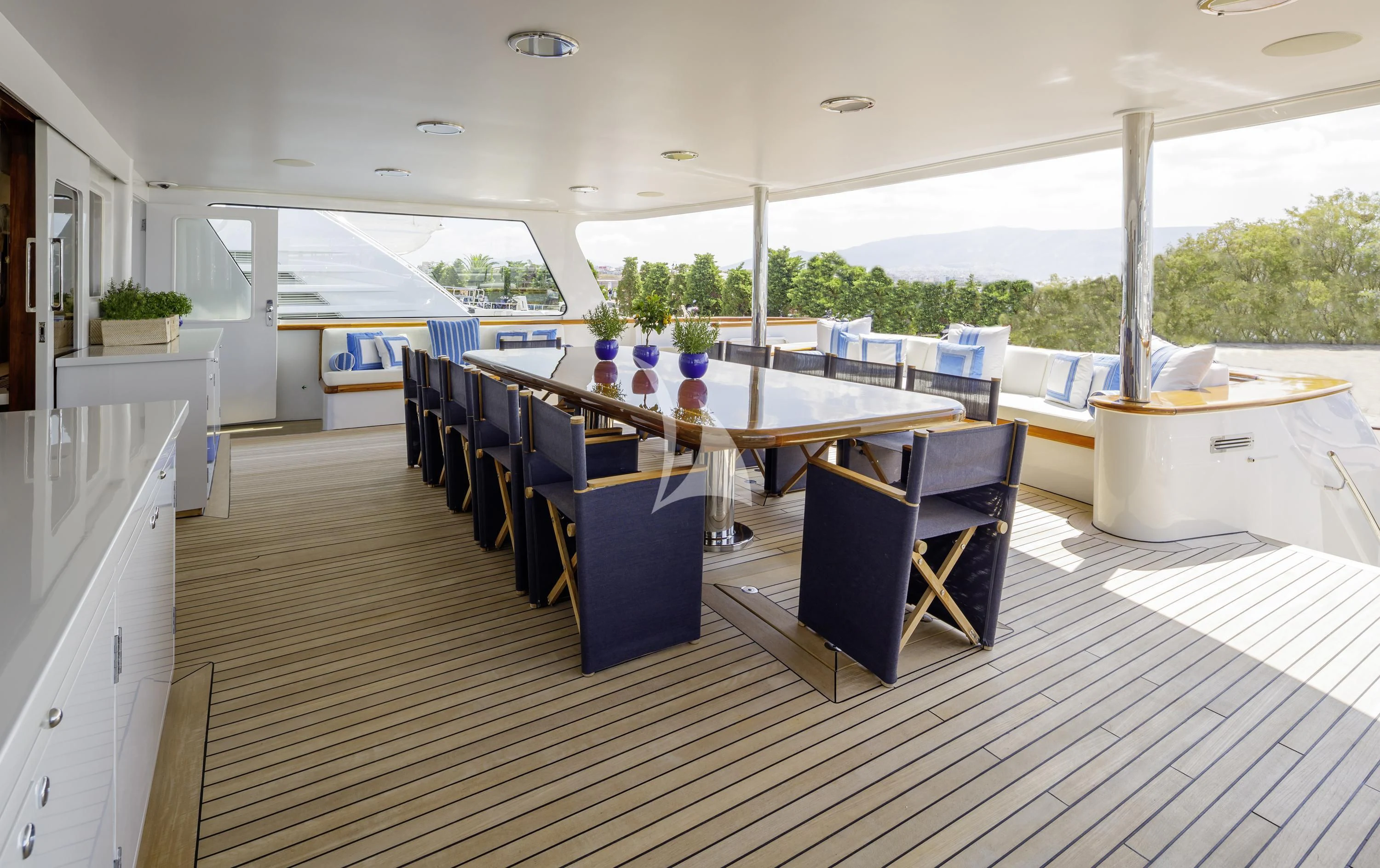 a large open house with a large table and chairs aboard ITOTO Yacht for Charter