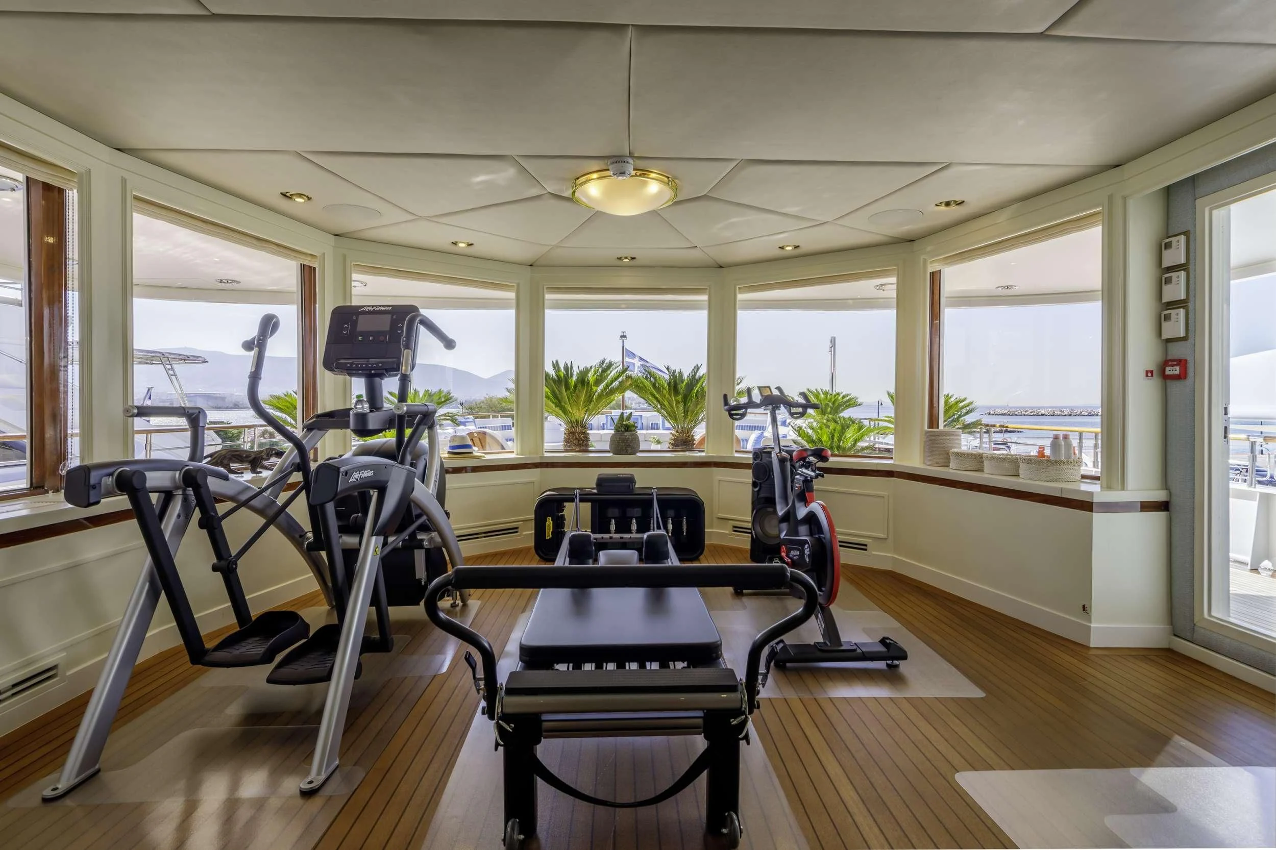 a room with tables and chairs aboard ITOTO Yacht for Charter