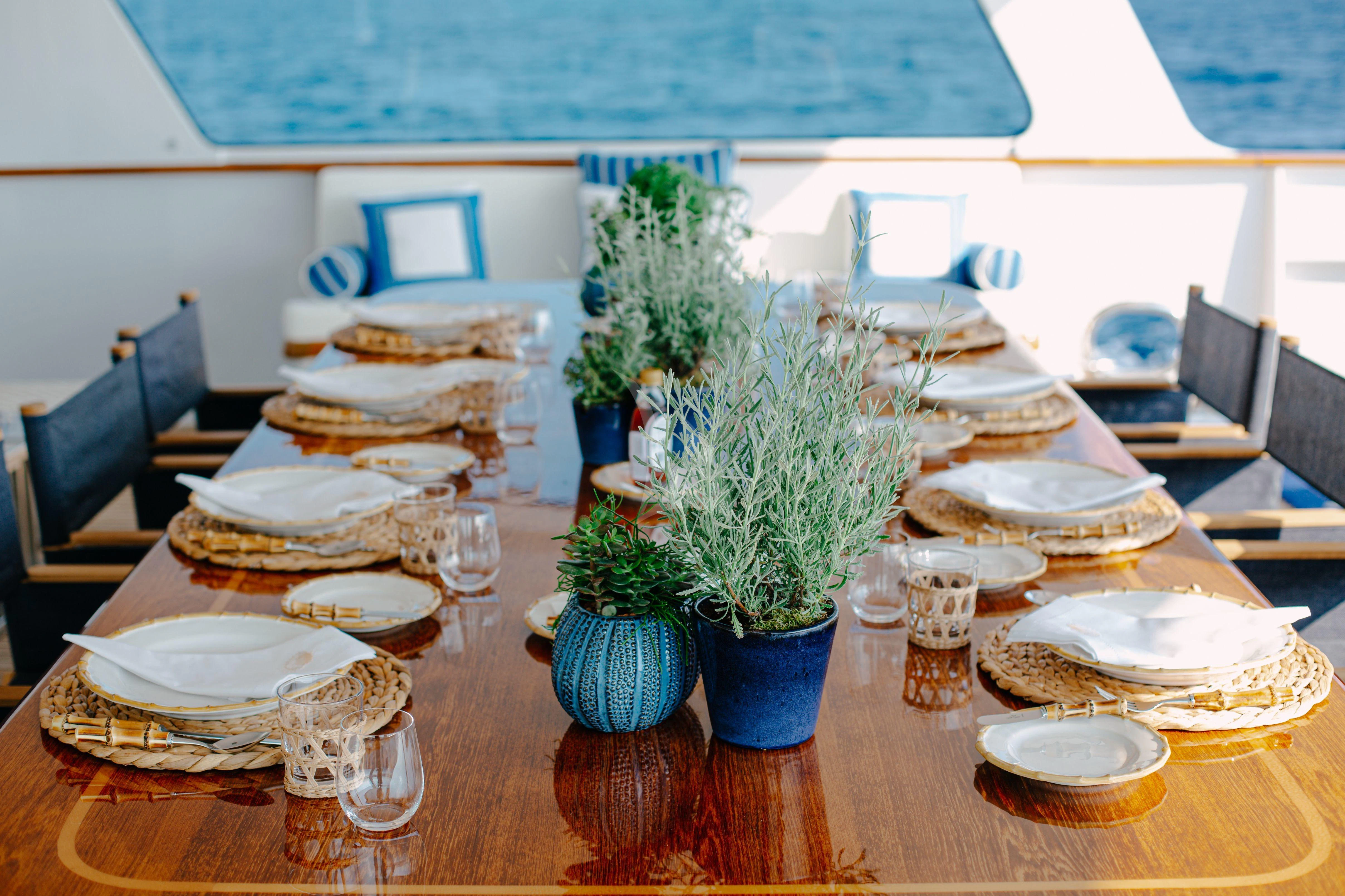 a table with plates and dishes on it aboard ITOTO Yacht for Charter