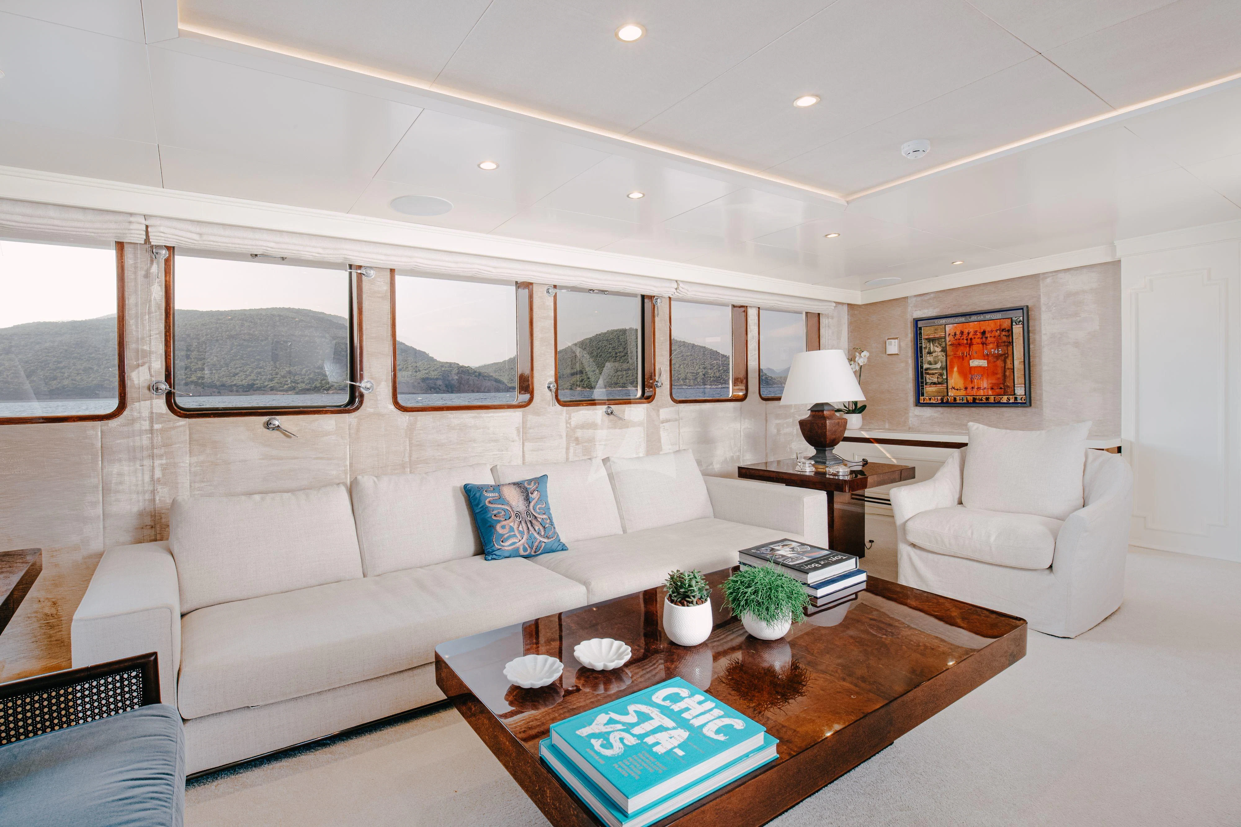 a living room with a white couch and a coffee table aboard ITOTO Yacht for Charter