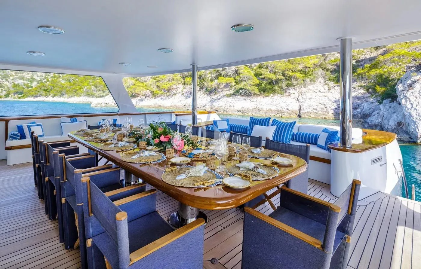 a table set for a meal on a deck aboard ITOTO Yacht for Charter
