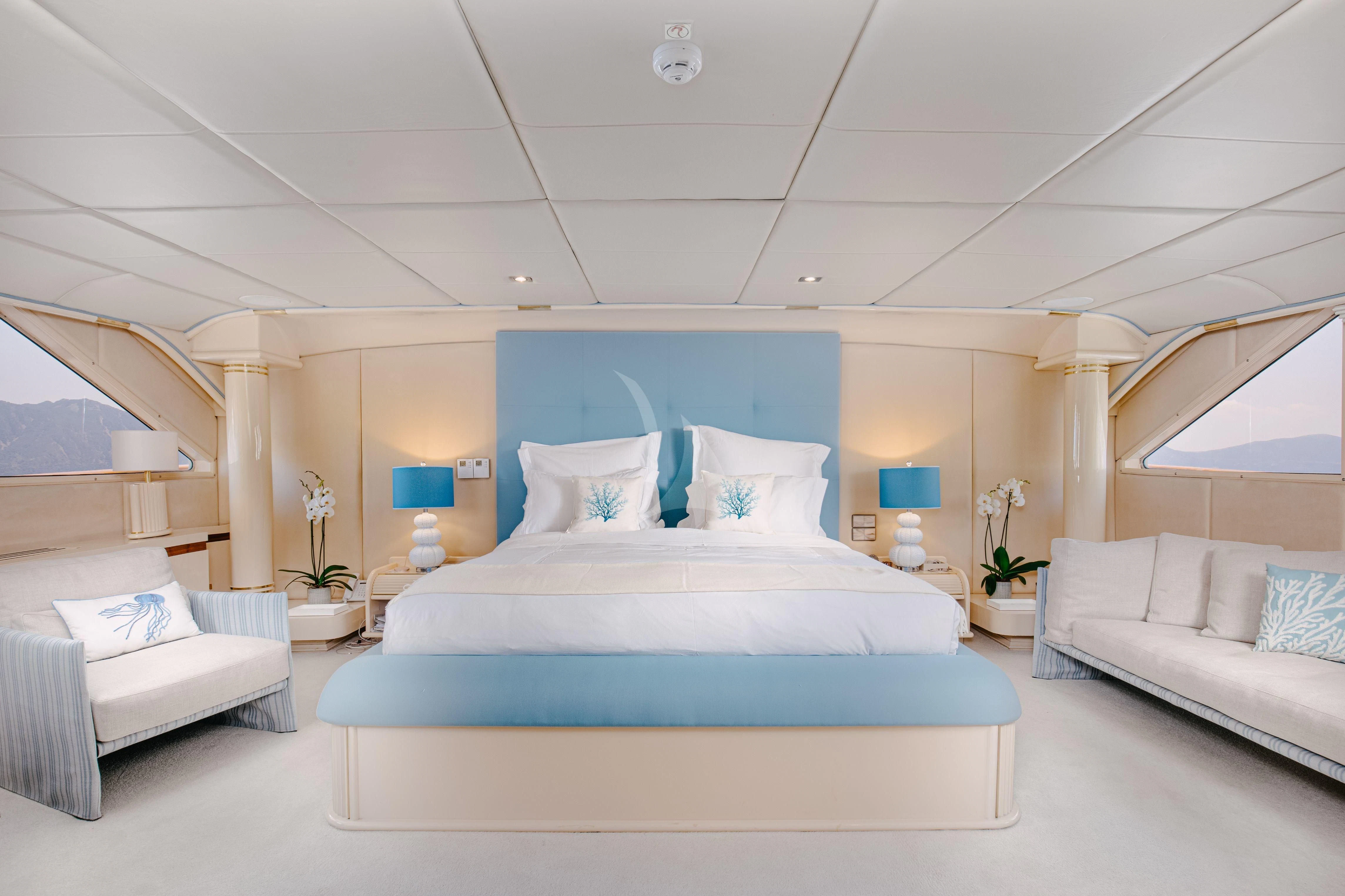 a room with a bed and a couch aboard ITOTO Yacht for Charter