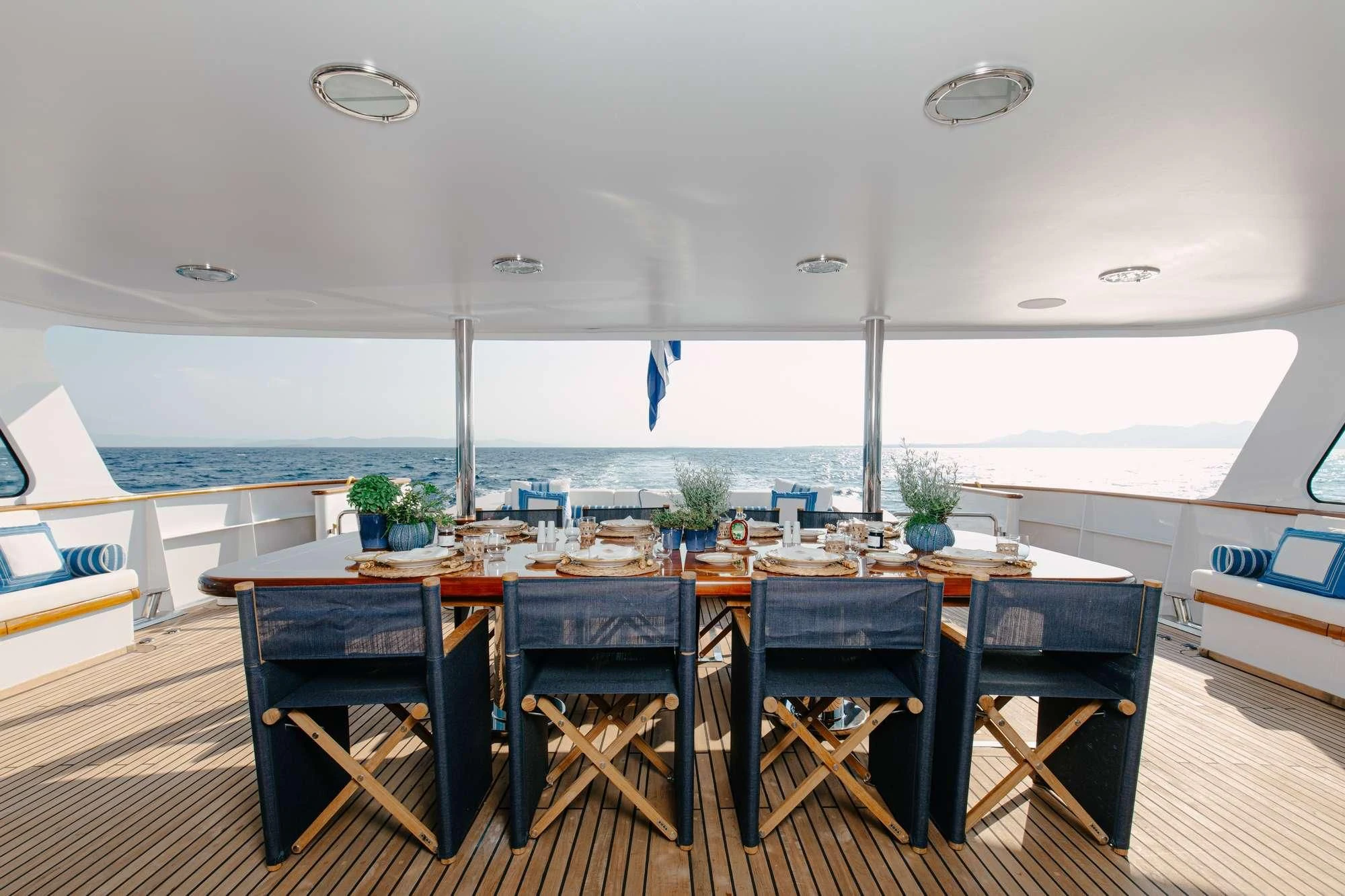 a table with chairs around it aboard ITOTO Yacht for Charter