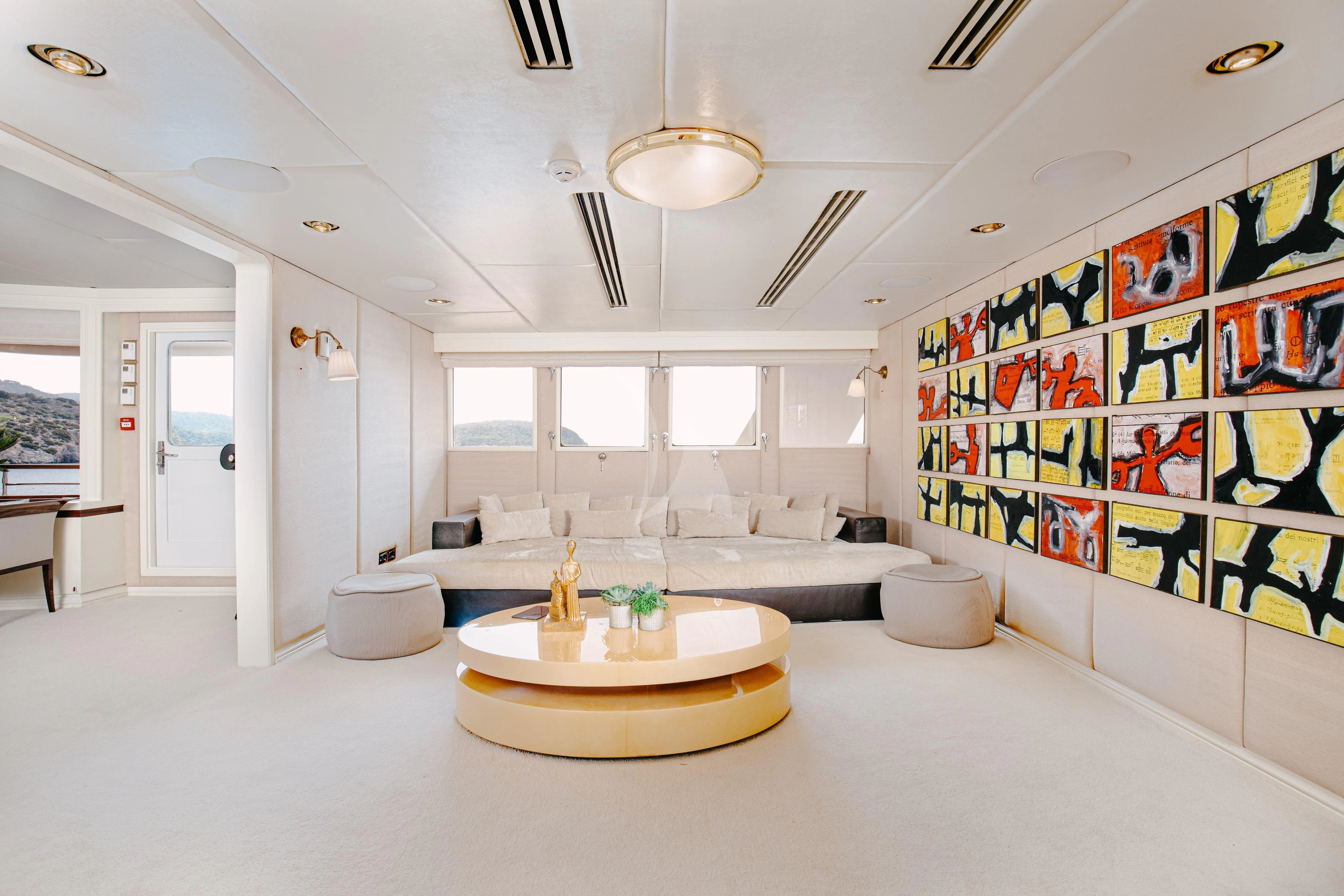 a large white room with a large white and yellow rug aboard ITOTO Yacht for Charter