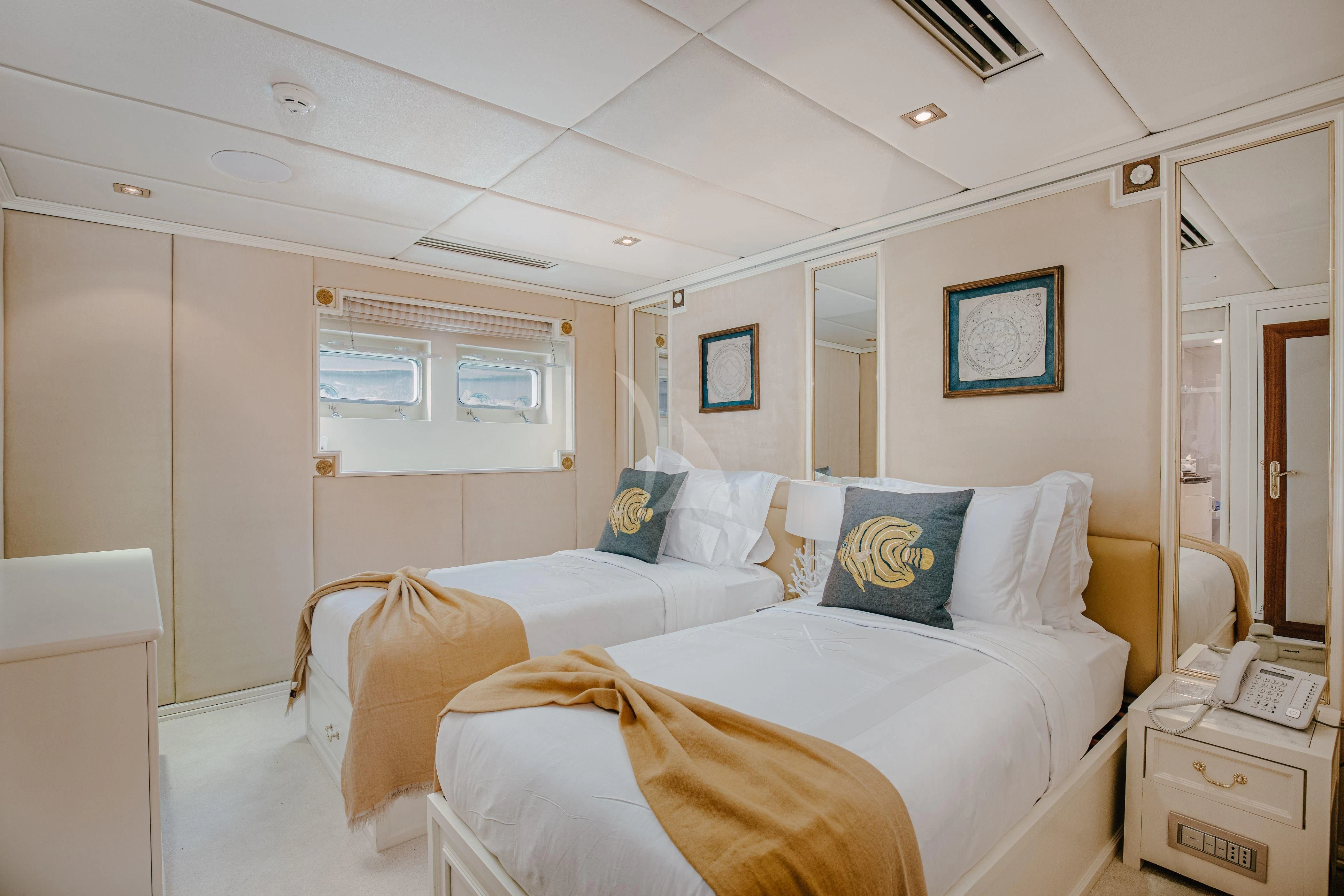 a room with beds and a window aboard ITOTO Yacht for Charter