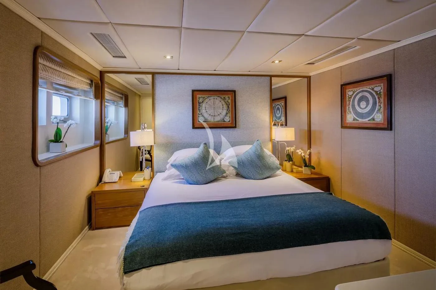 a bedroom with a blue bed aboard ITOTO Yacht for Charter
