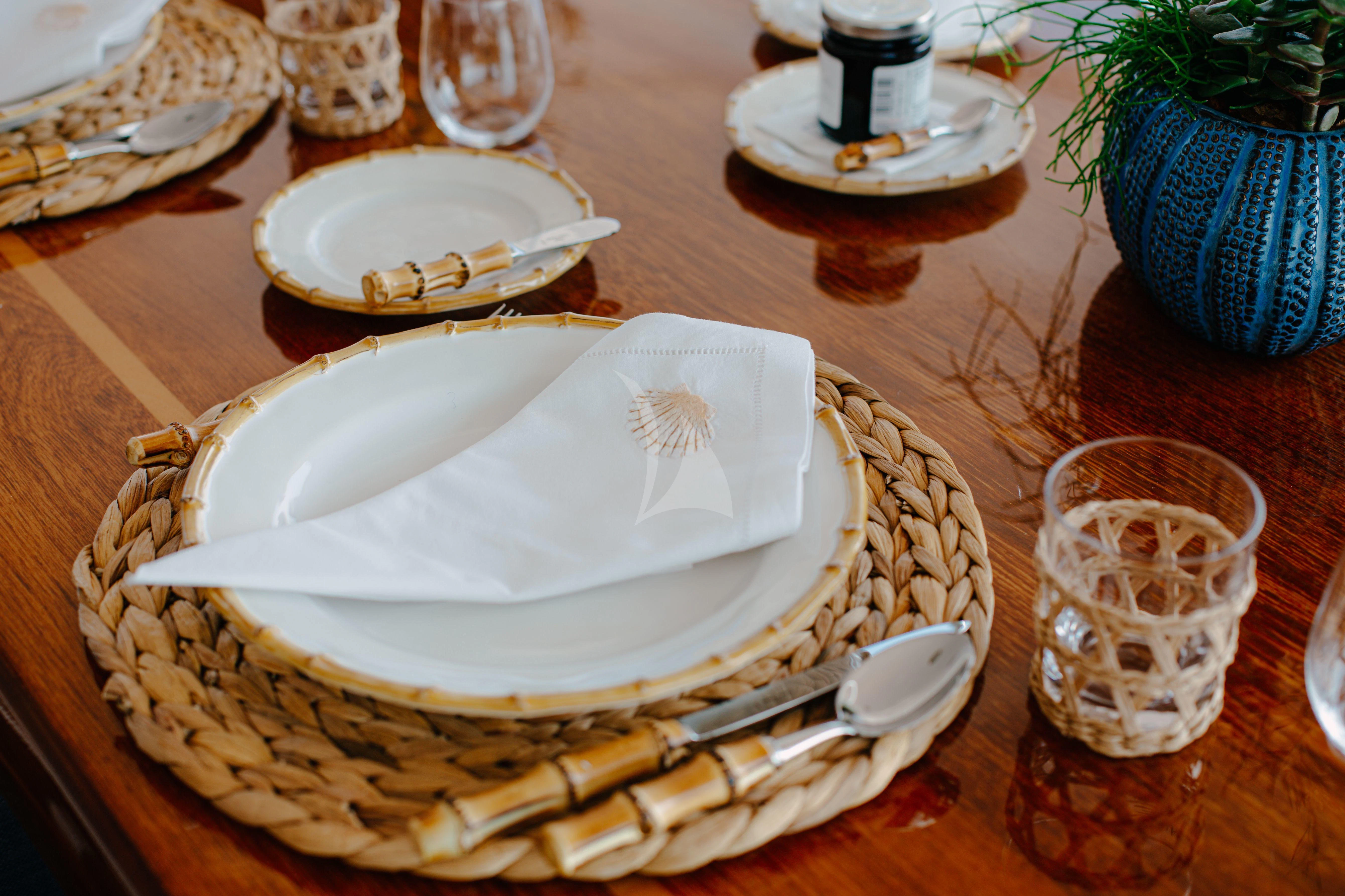 a plate of food and a glass of water on a table aboard ITOTO Yacht for Charter