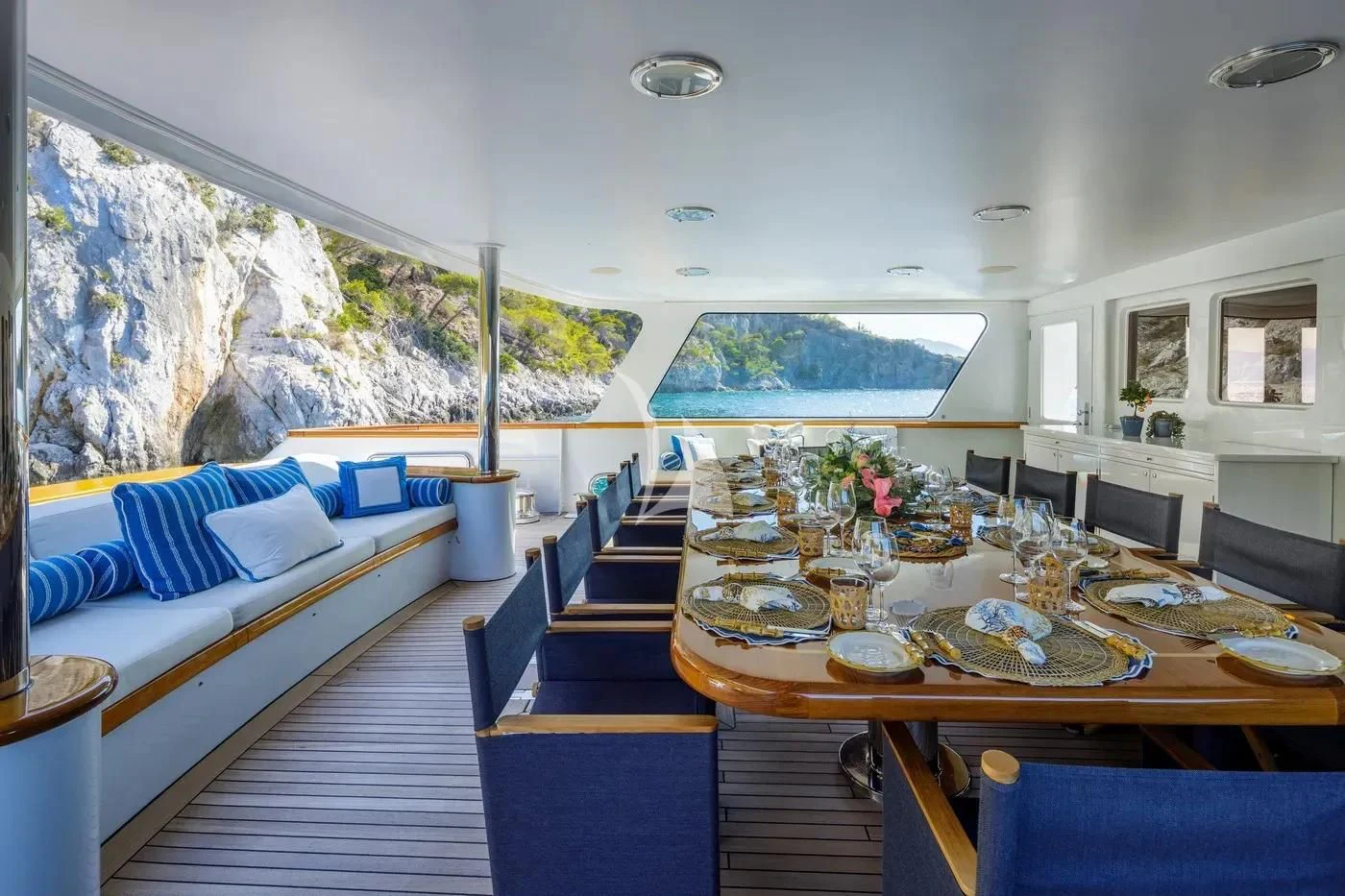 a room with a table and chairs aboard ITOTO Yacht for Charter