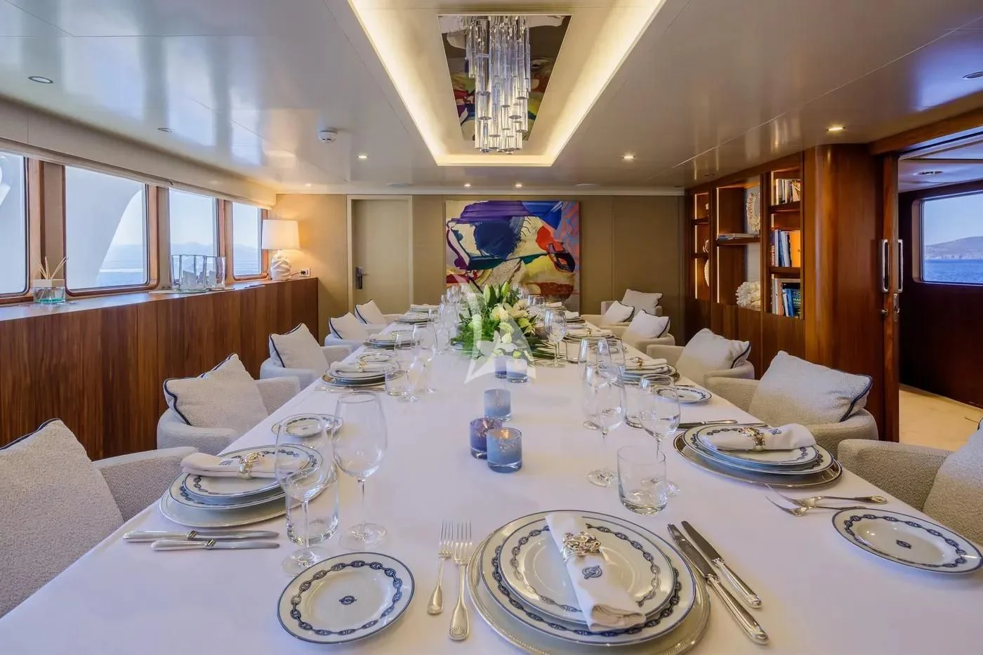 a large dining table with plates and glasses aboard ITOTO Yacht for Charter