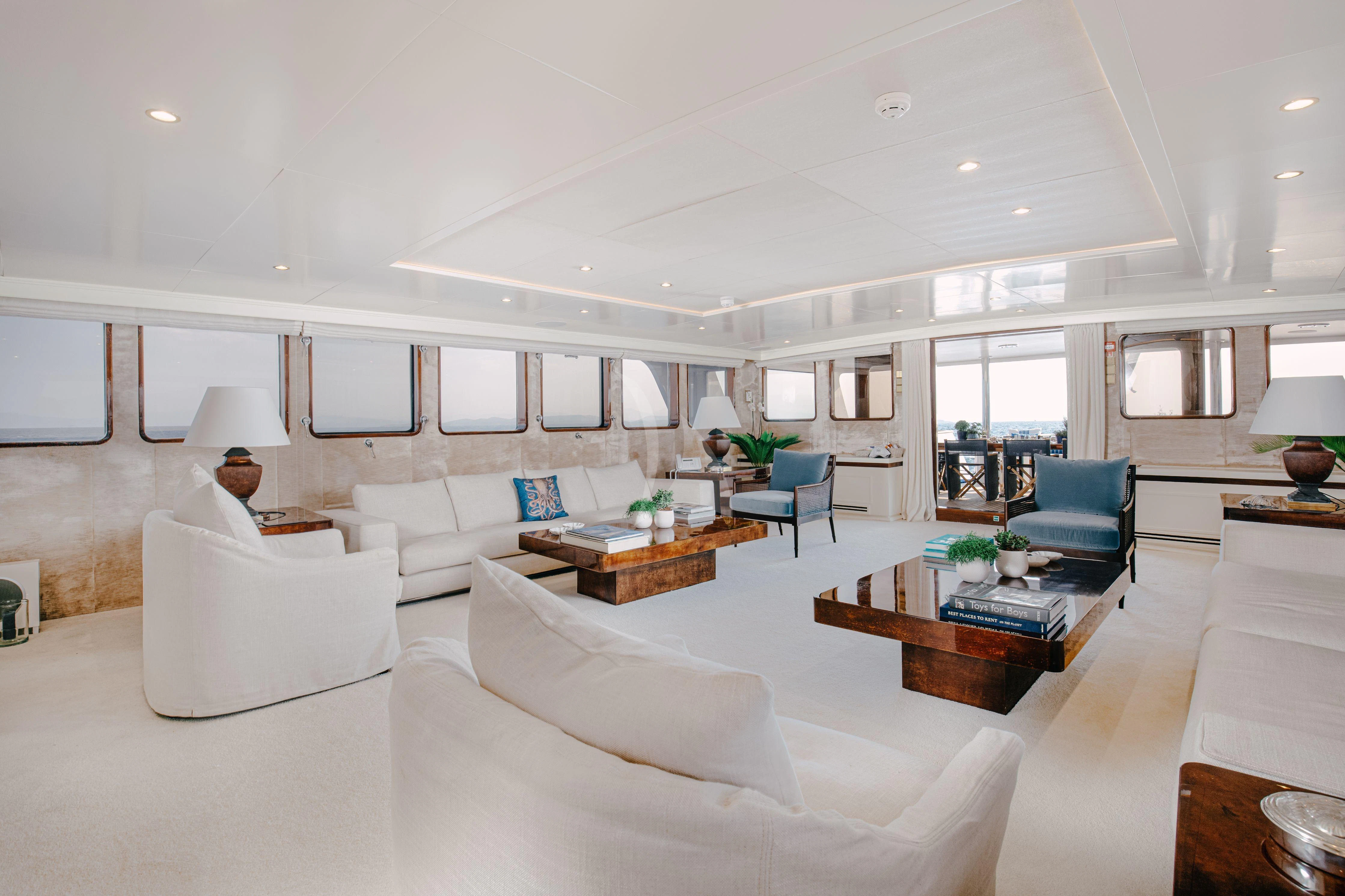 a living room with white furniture aboard ITOTO Yacht for Charter