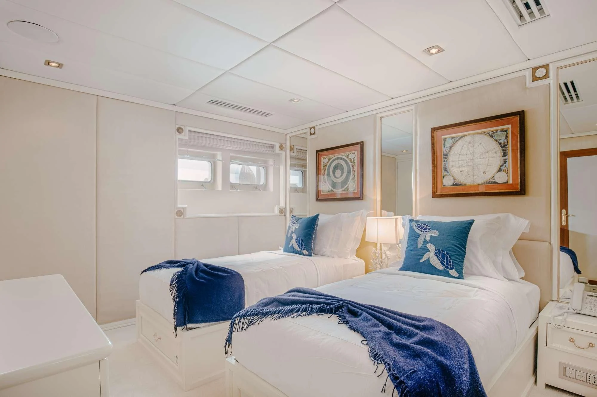 a room with white bedding aboard ITOTO Yacht for Charter